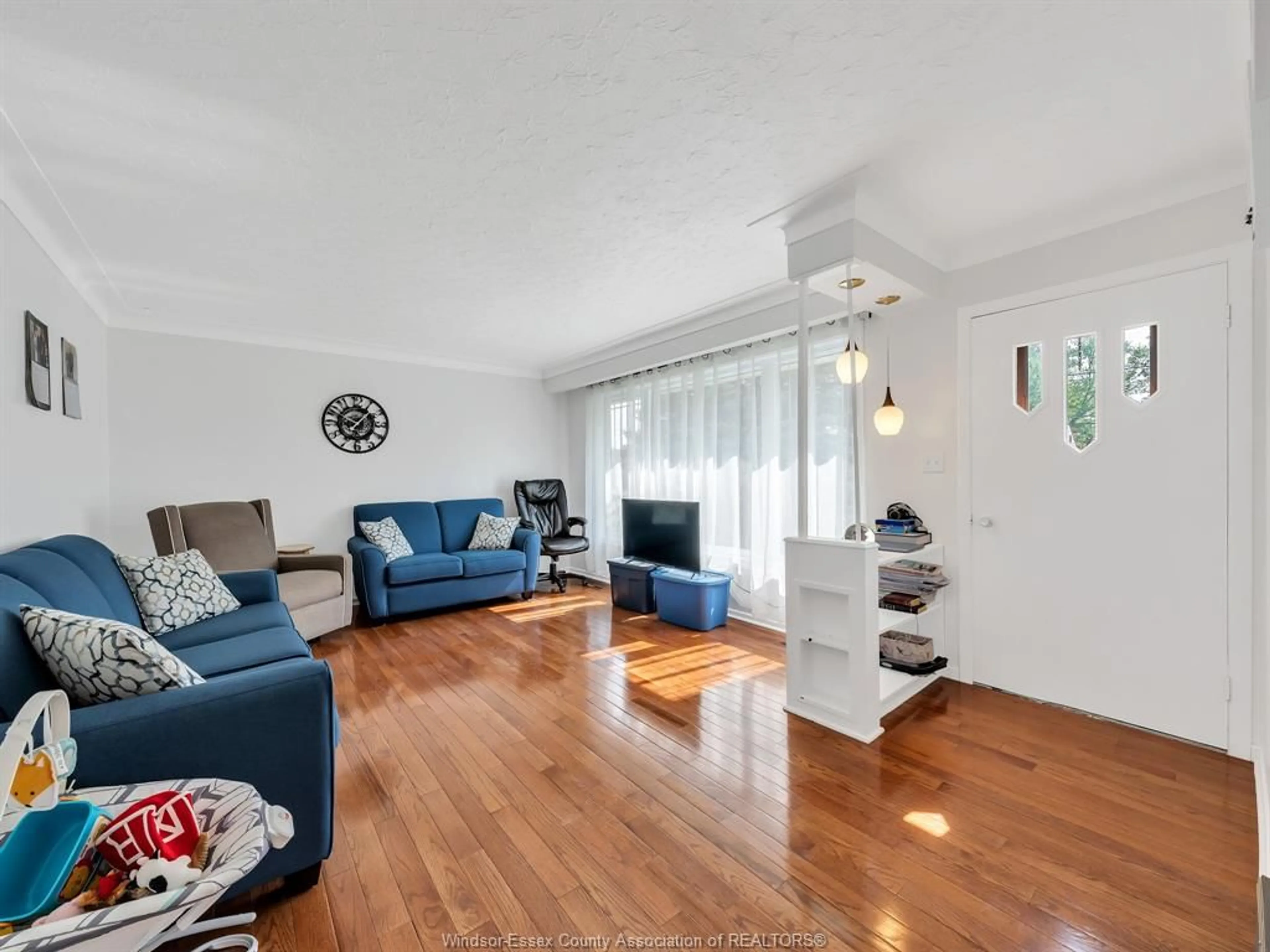 Living room with furniture, wood/laminate floor for 571 Highway 77, Leamington Ontario N8H 3V8