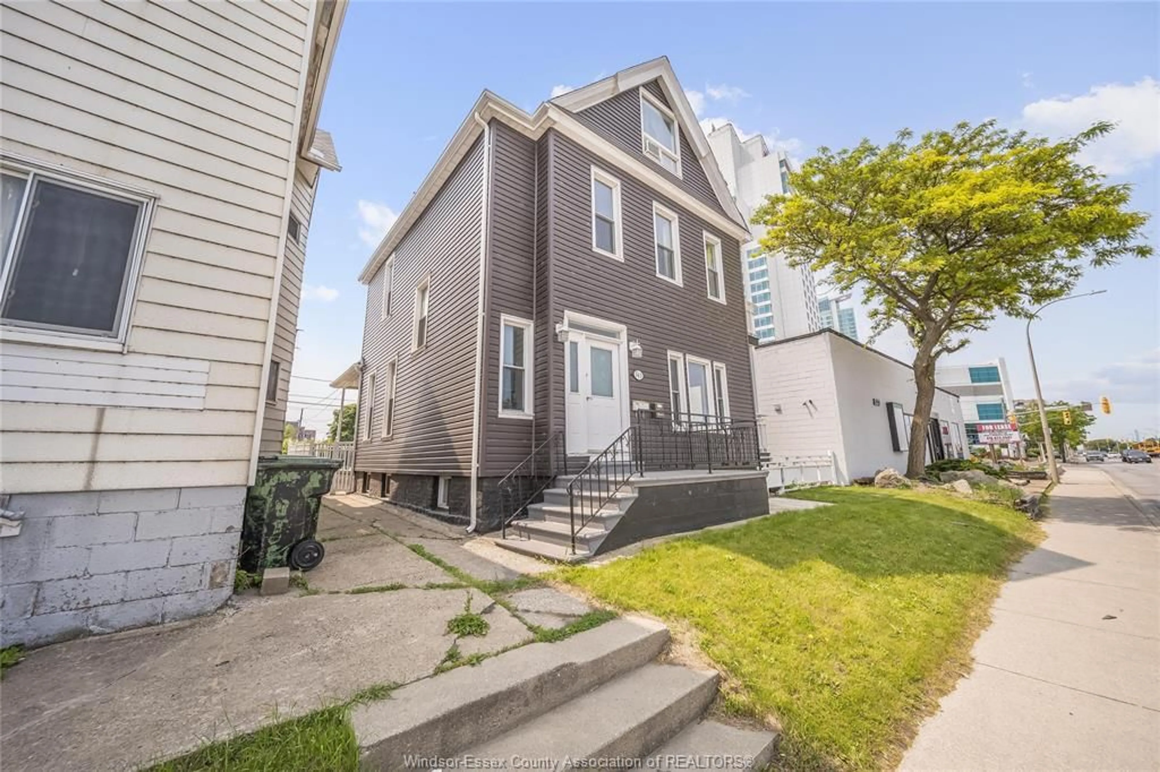 Home with vinyl exterior material, street for 561 RIVERSIDE Dr, Windsor Ontario N9A 2T1