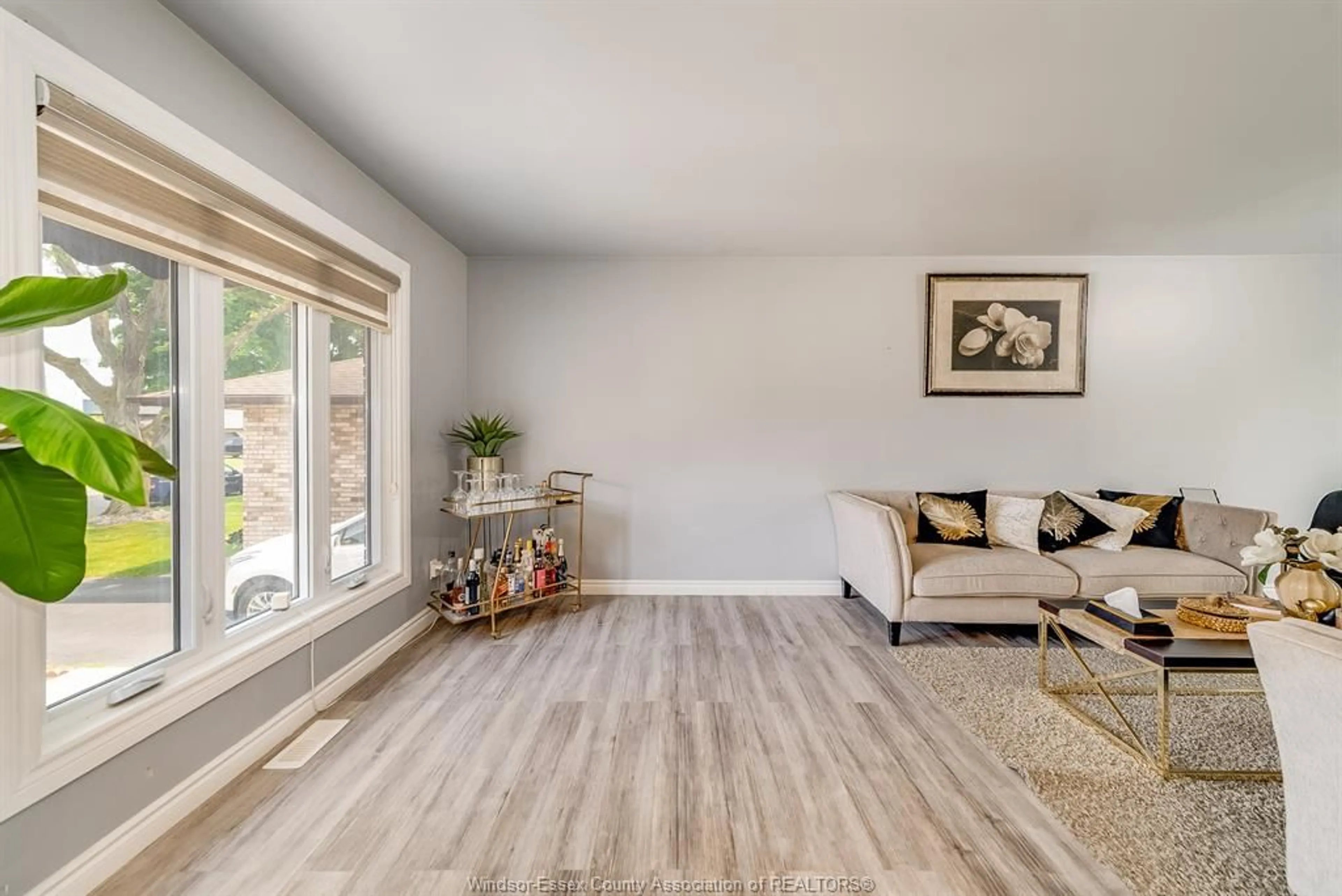 Living room with furniture, wood/laminate floor for 3169 CLEMENCEAU Blvd, Windsor Ontario N8T 2R6