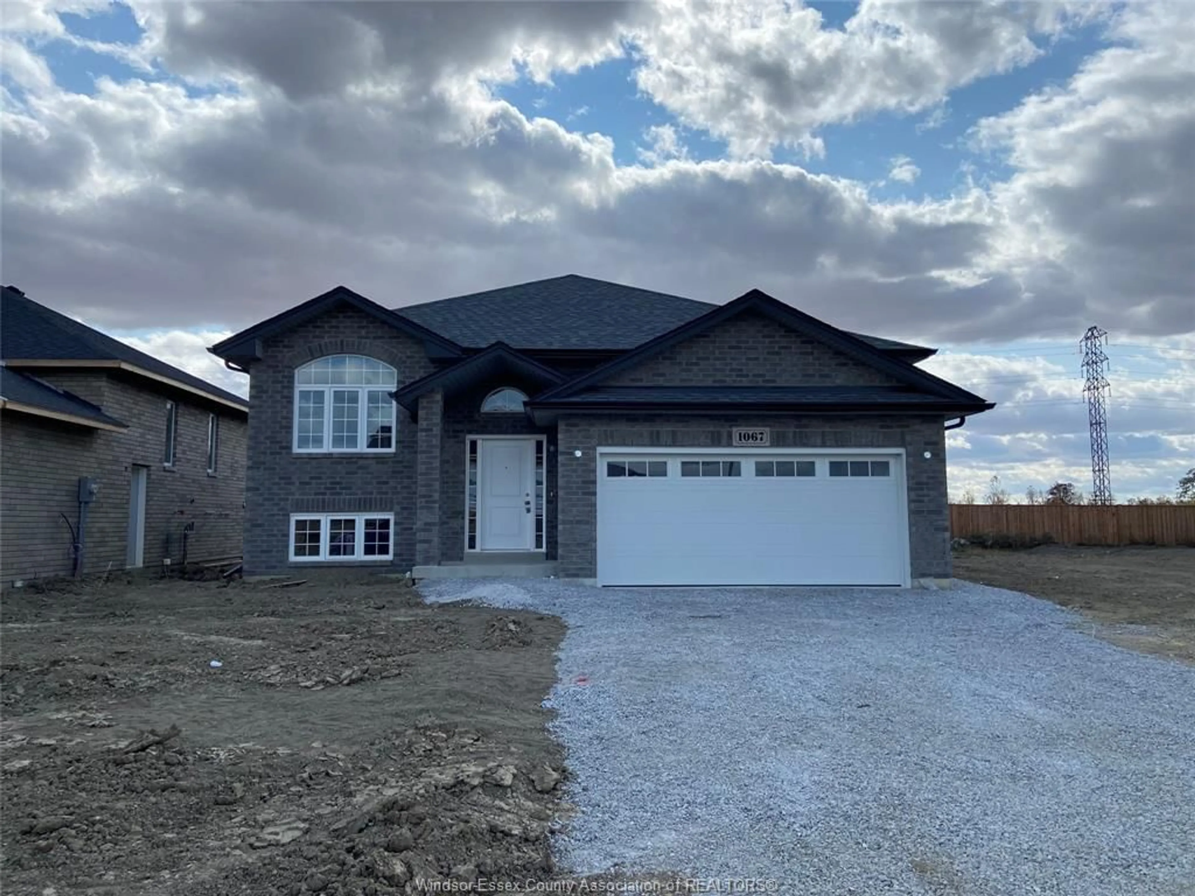 Home with brick exterior material, street for 1067 ASPEN RIDGE Cres, Lakeshore Ontario N0R 1A0