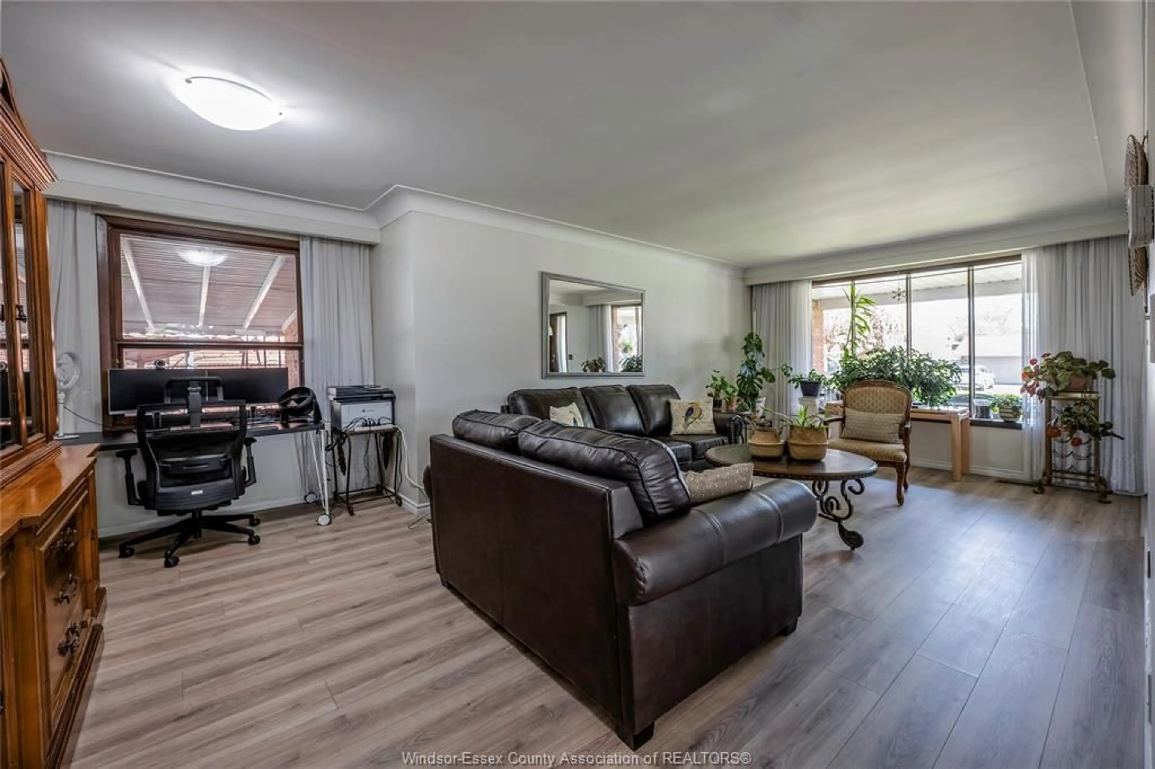 Living room with furniture, wood/laminate floor for 9610 Asgard Rd, Windsor Ontario N8R 1E2