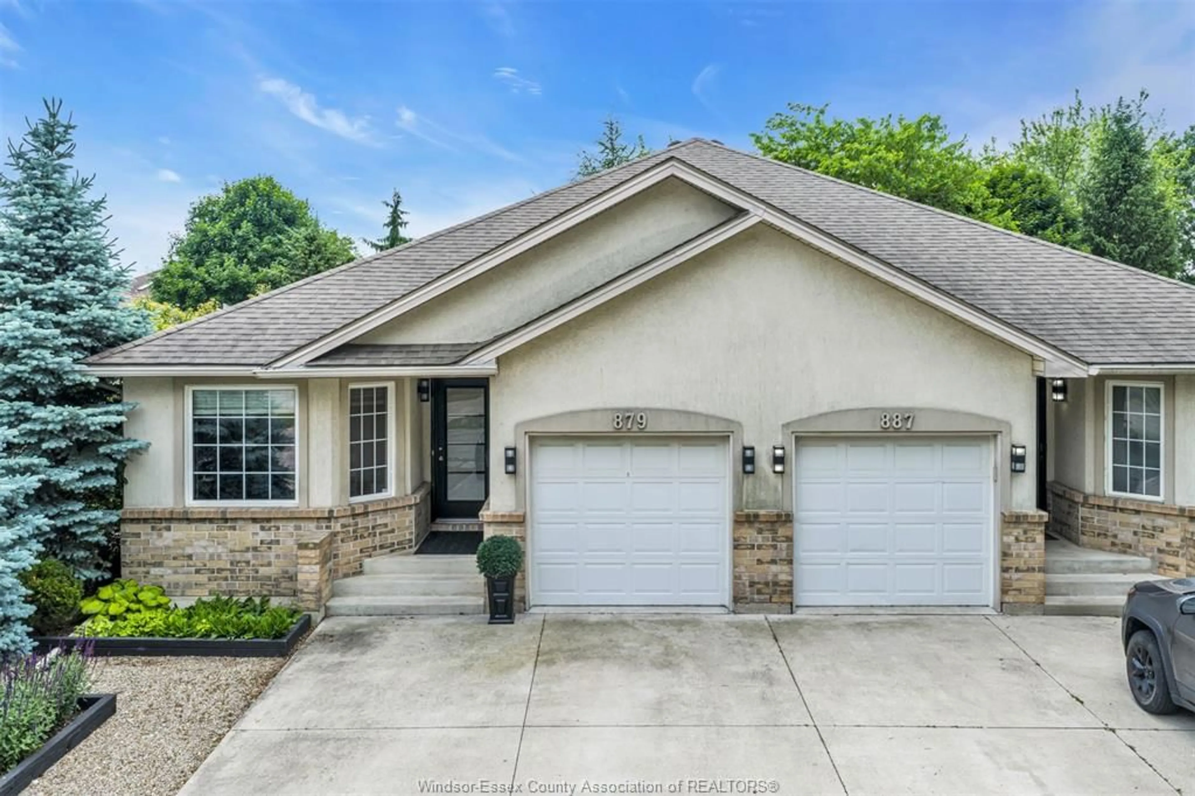 Home with brick exterior material, street for 879 COUSINEAU Rd, Windsor Ontario N9G 1V6