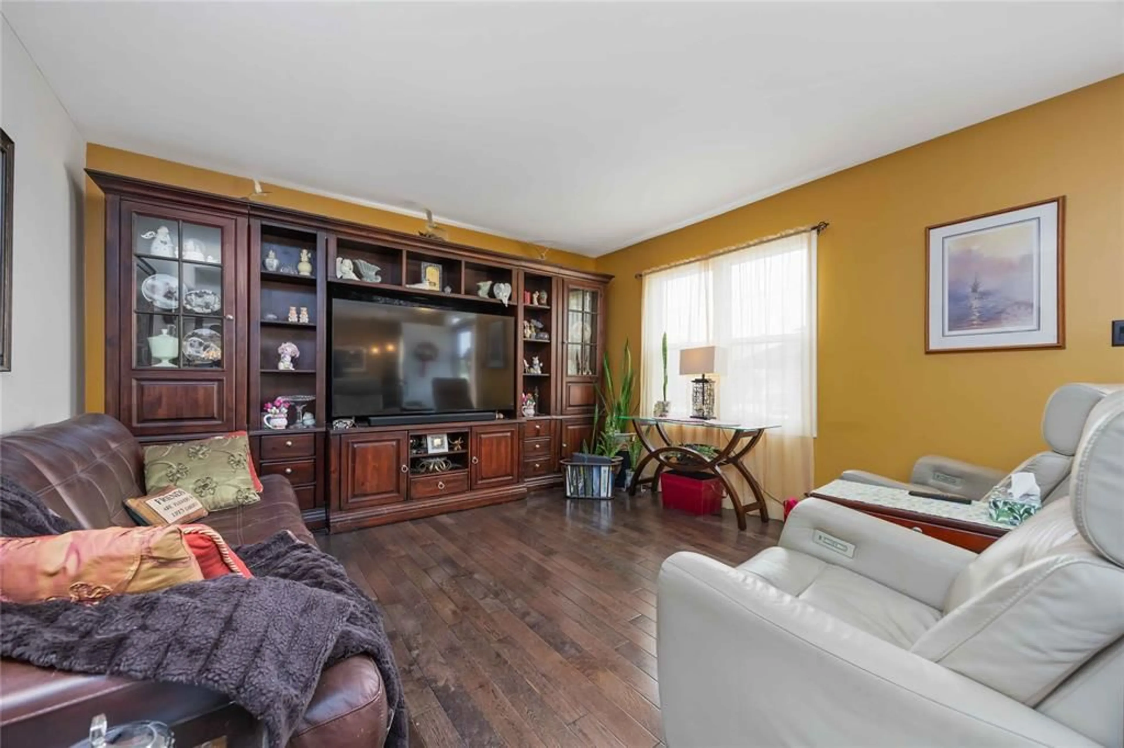 Living room with furniture, wood/laminate floor for 1220 Pulteney St, Moore Township Ontario N0N 1M0