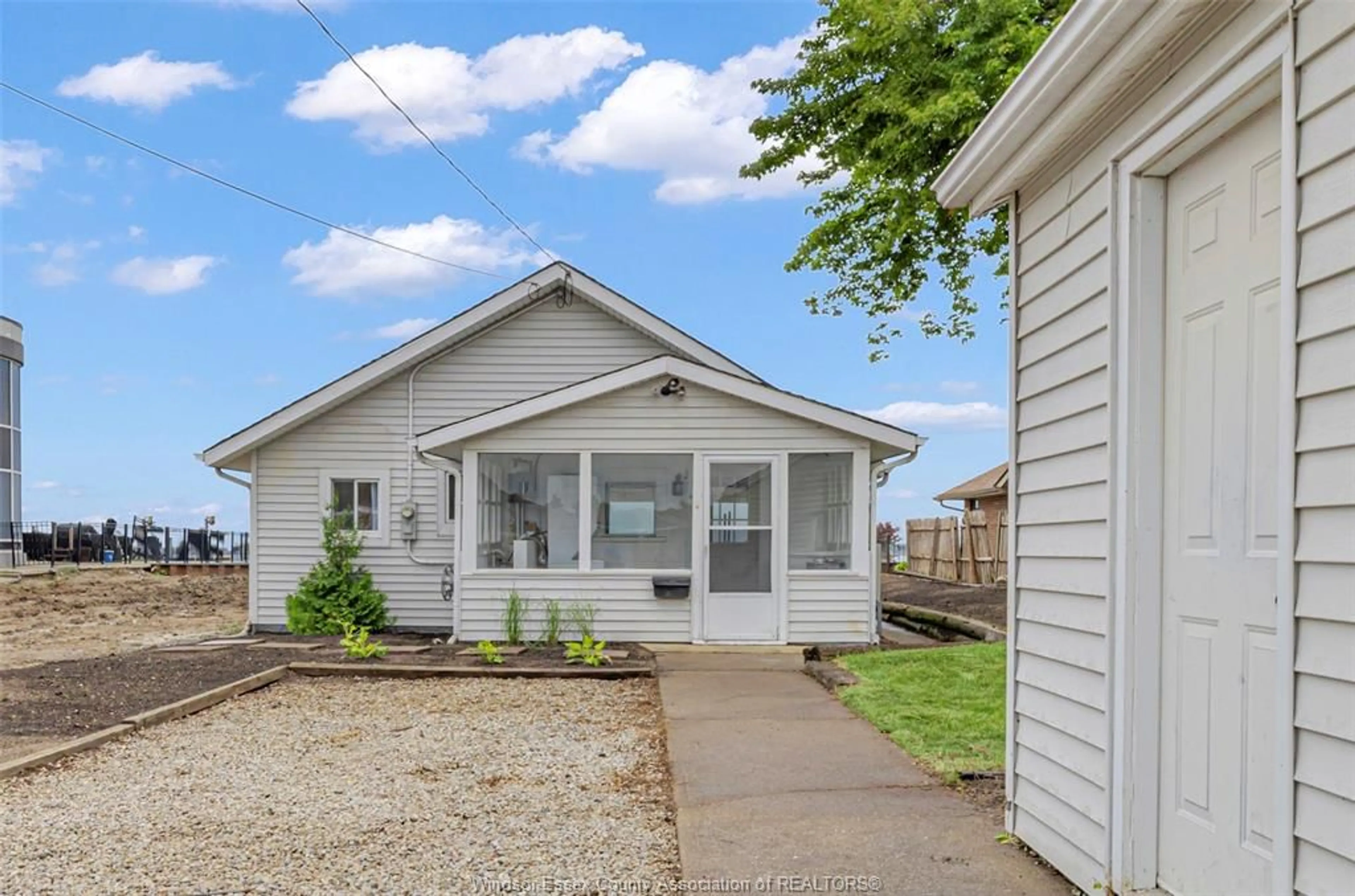 Home with vinyl exterior material, street for 8266 Riverside, Windsor Ontario N8S 1E6