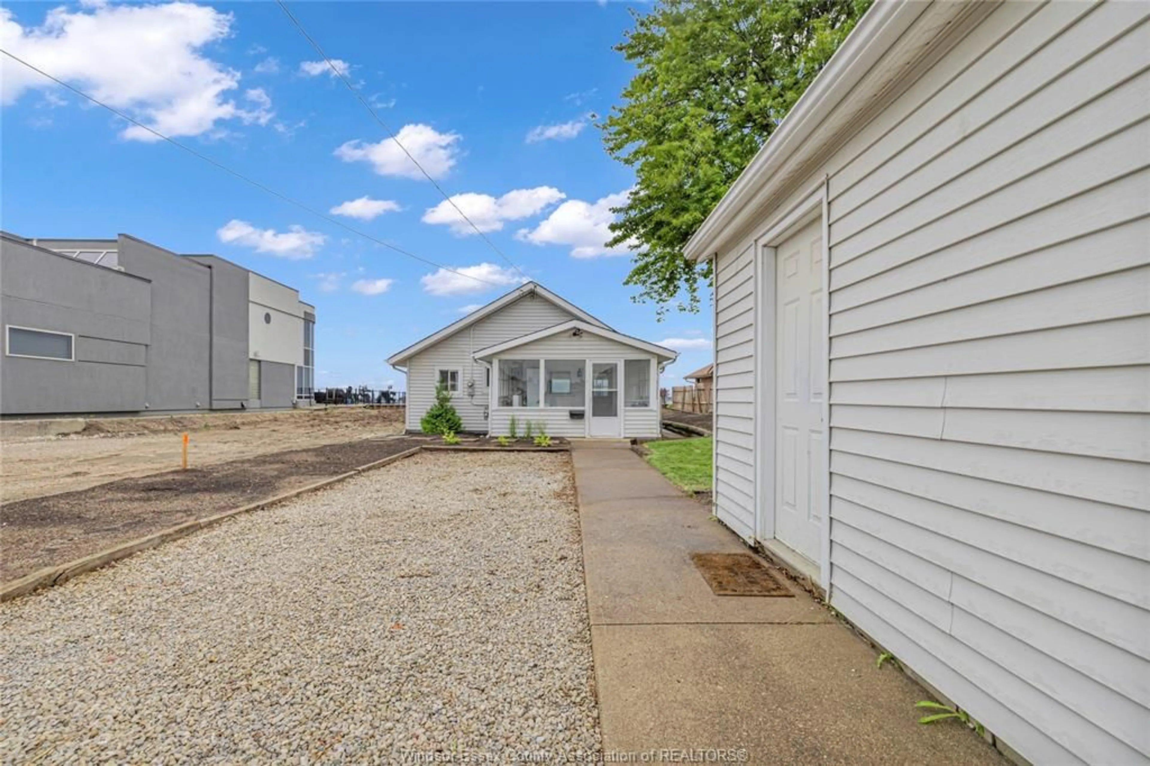 A pic from outside/outdoor area/front of a property/back of a property/a pic from drone, street for 8266 Riverside, Windsor Ontario N8S 1E6