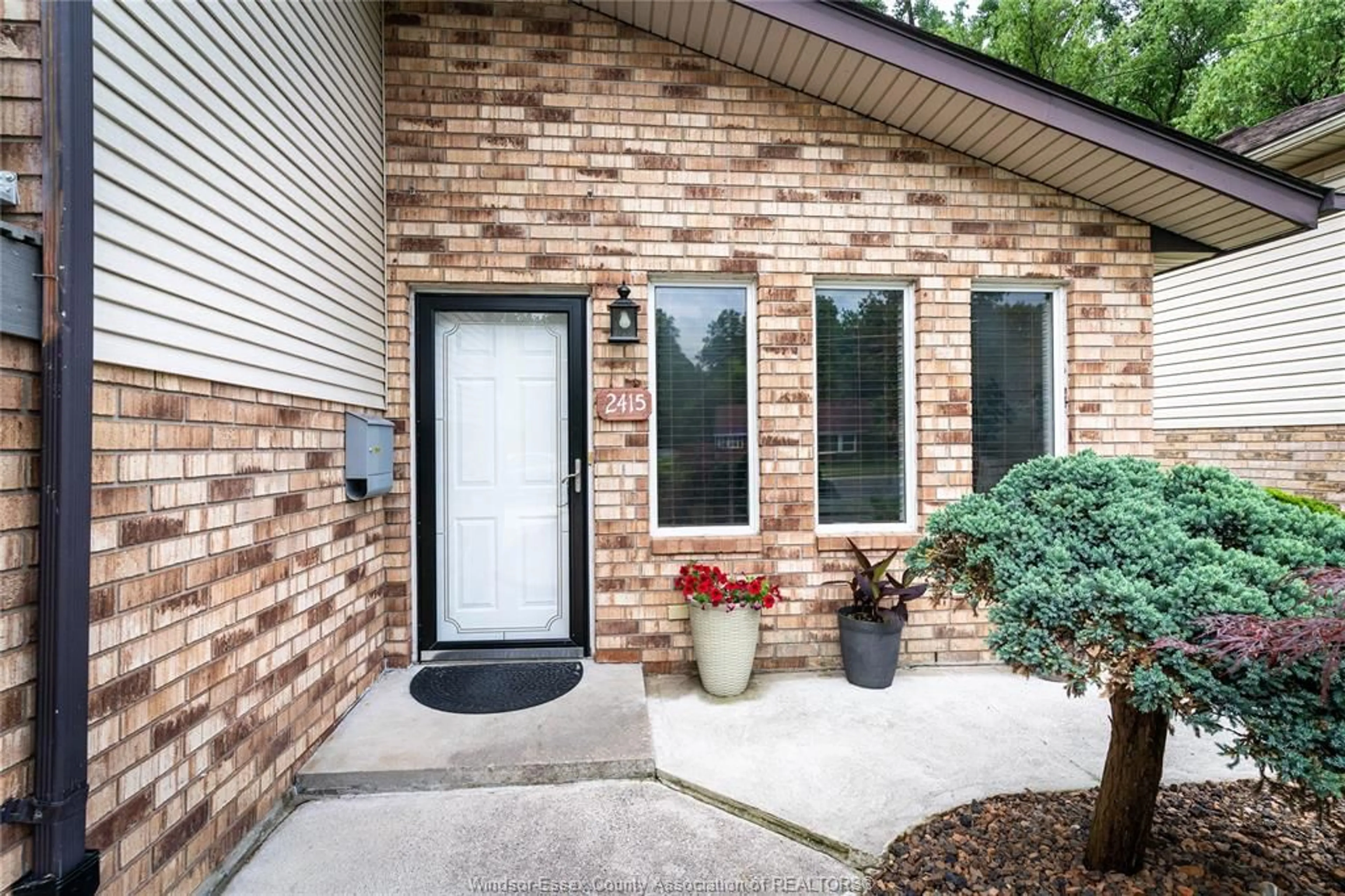 Home with brick exterior material, street for 2415 CABANA ROAD  W, Windsor Ontario N9G 1E2