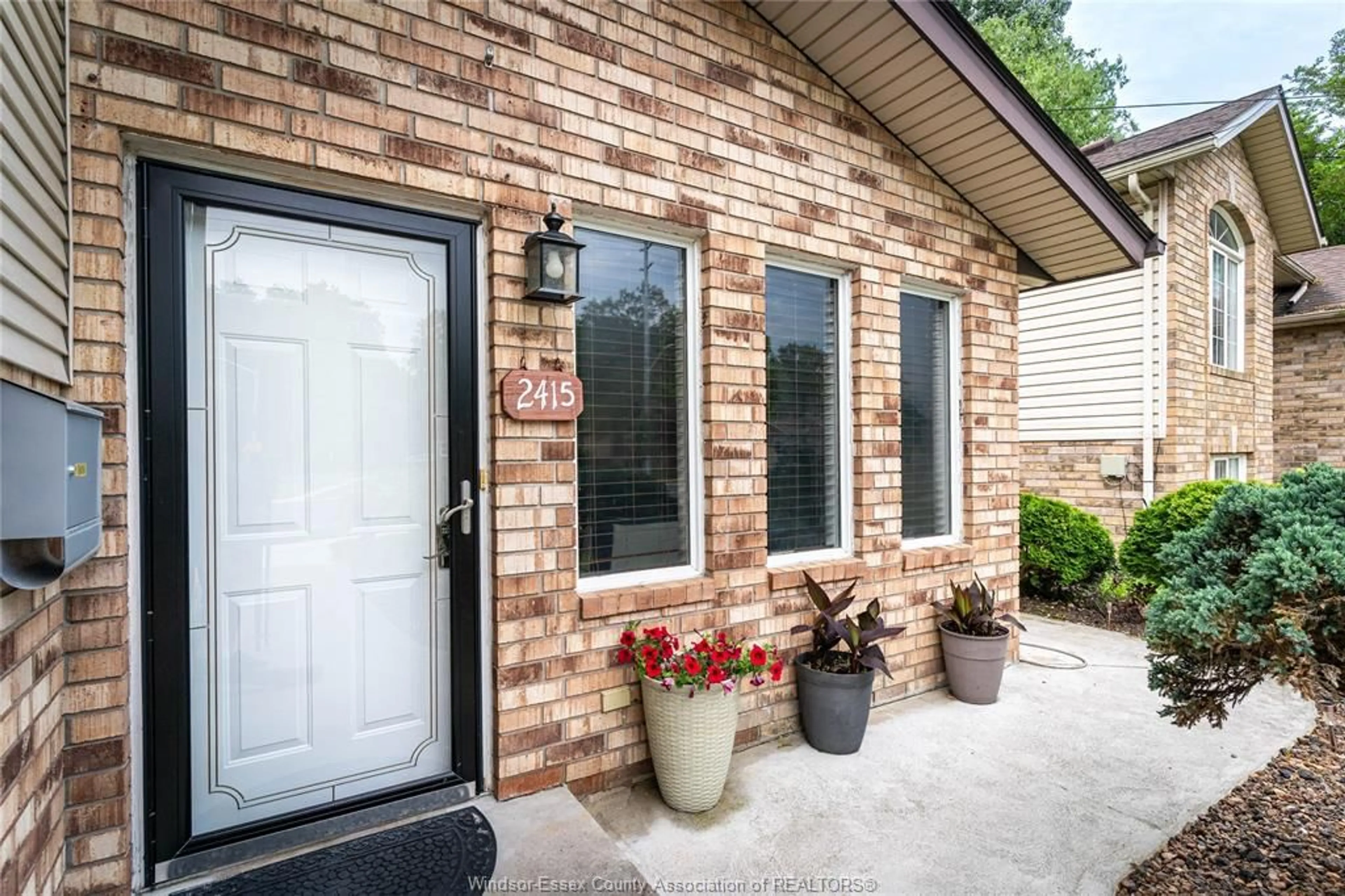 Home with brick exterior material, street for 2415 CABANA ROAD  W, Windsor Ontario N9G 1E2