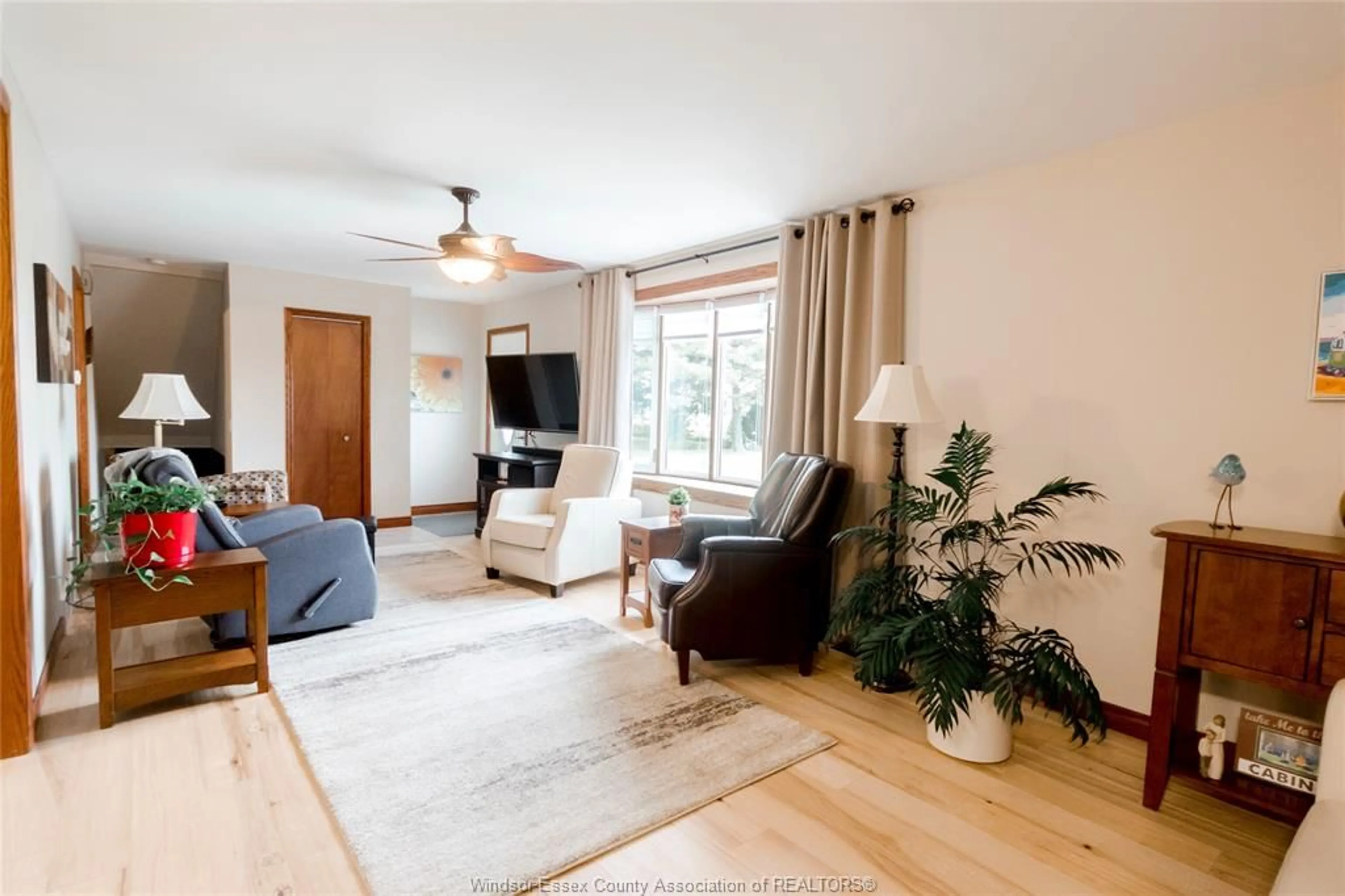 Living room with furniture, wood/laminate floor for 13496 13TH CONCESSION, Essex Ontario N8M 2X6