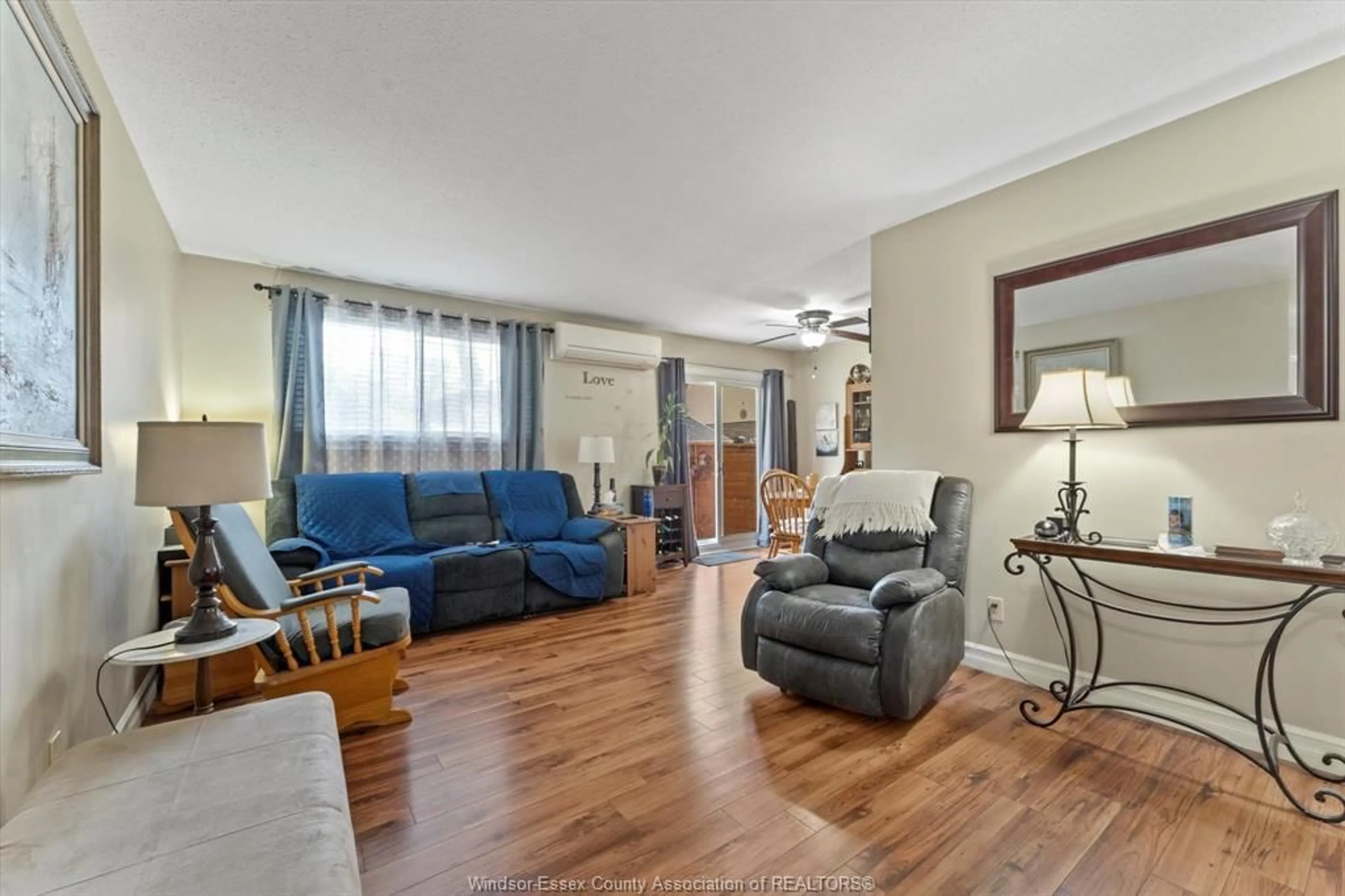 Living room with furniture, wood/laminate floor for 8549 FOXHILL Pl, Windsor Ontario N8S 4J1