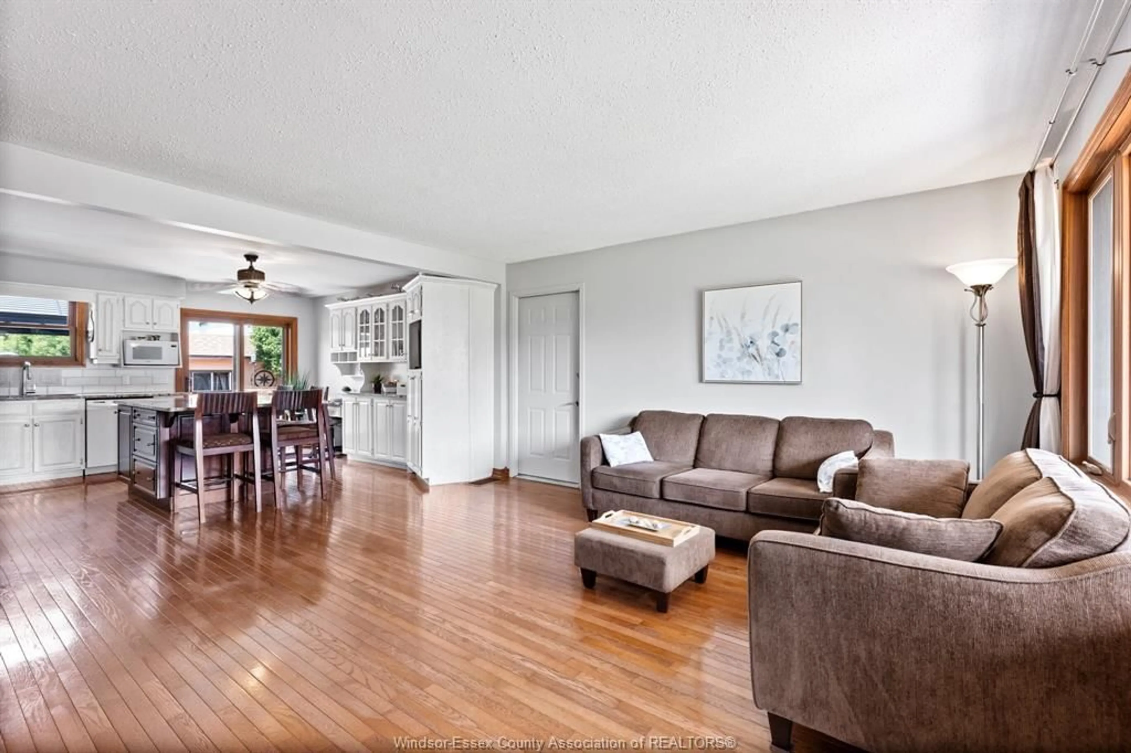 Living room with furniture, wood/laminate floor for 12680 KIMBERLY Dr, Tecumseh Ontario N8N 3H7