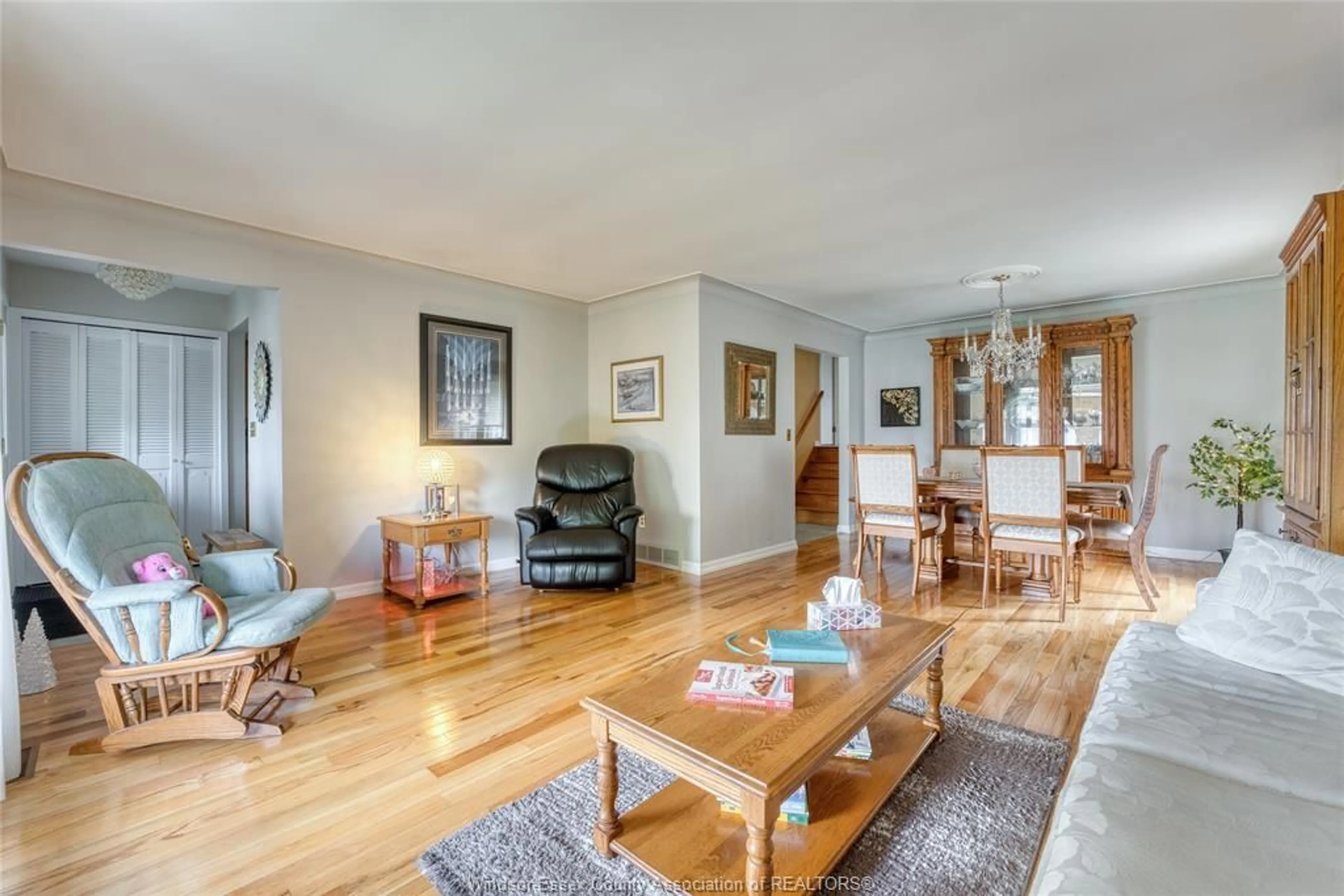 Living room with furniture, wood/laminate floor for 9944 HOLLY Cres, Windsor Ontario N9V 2R8