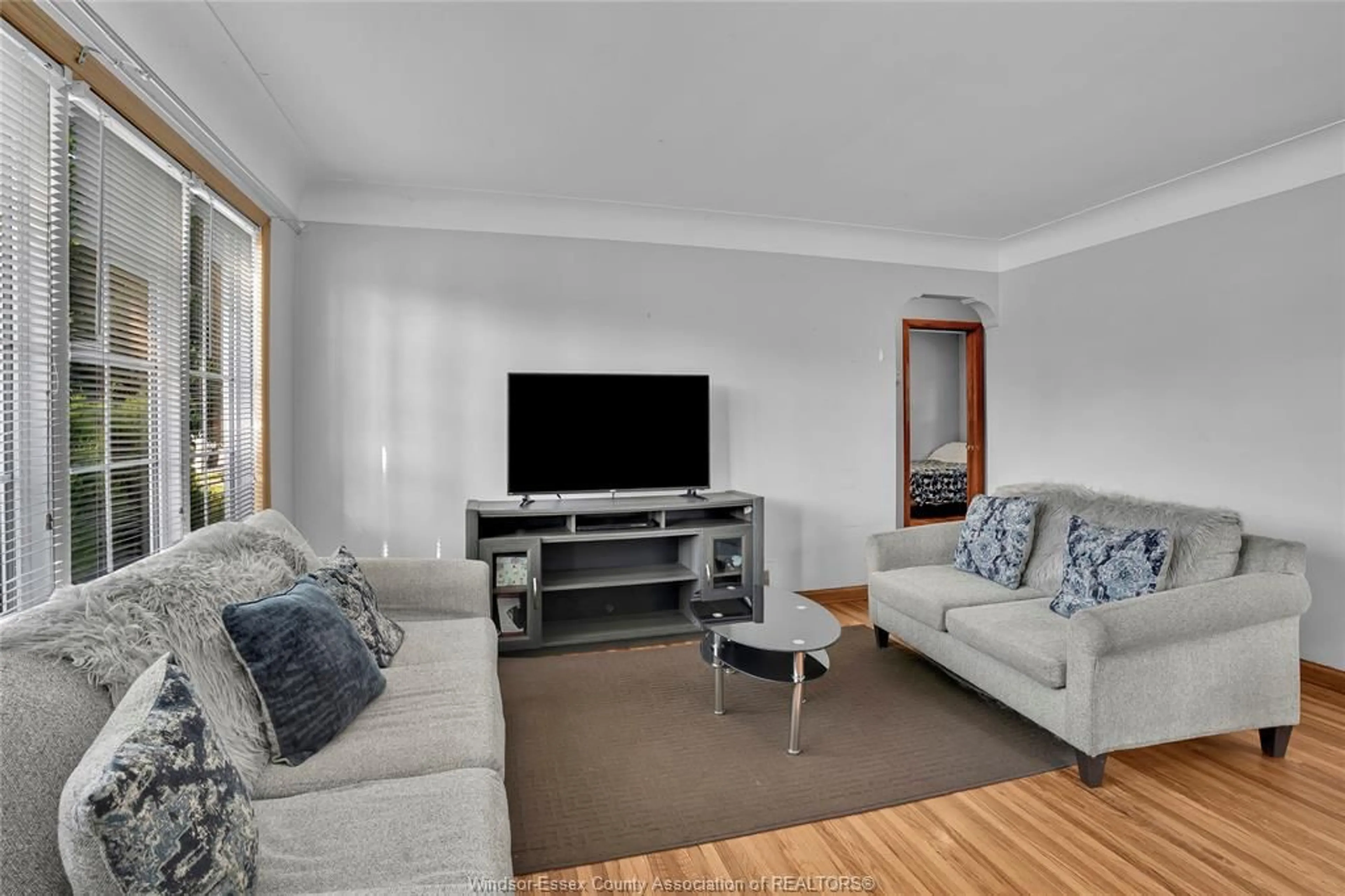 Living room with furniture, wood/laminate floor for 824 YPRES Ave, Windsor Ontario N8W 1P8