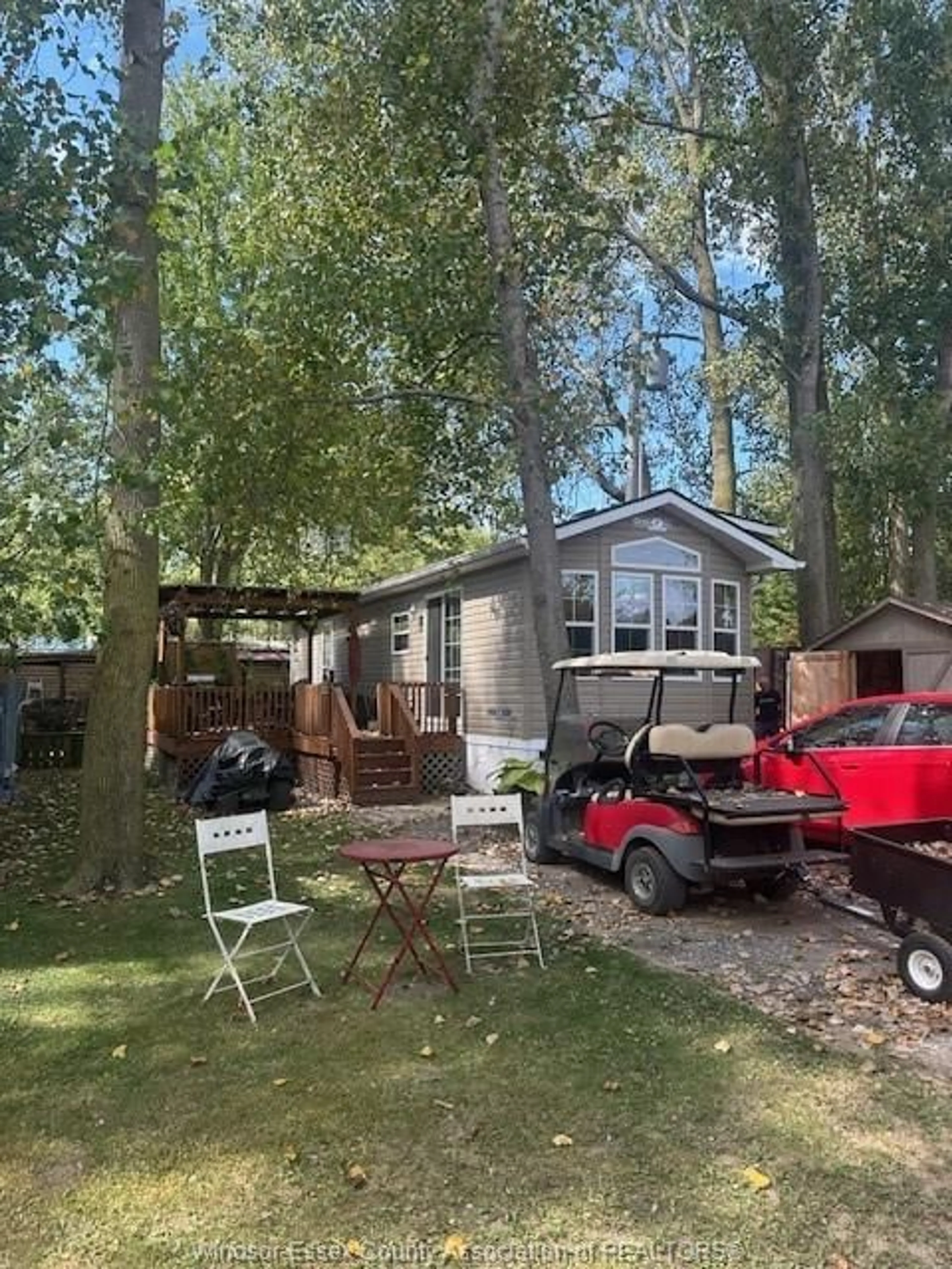 A pic from outside/outdoor area/front of a property/back of a property/a pic from drone, forest/trees view for 126 MERSEA RD 5 #16, Leamington Ontario N8H 3V5