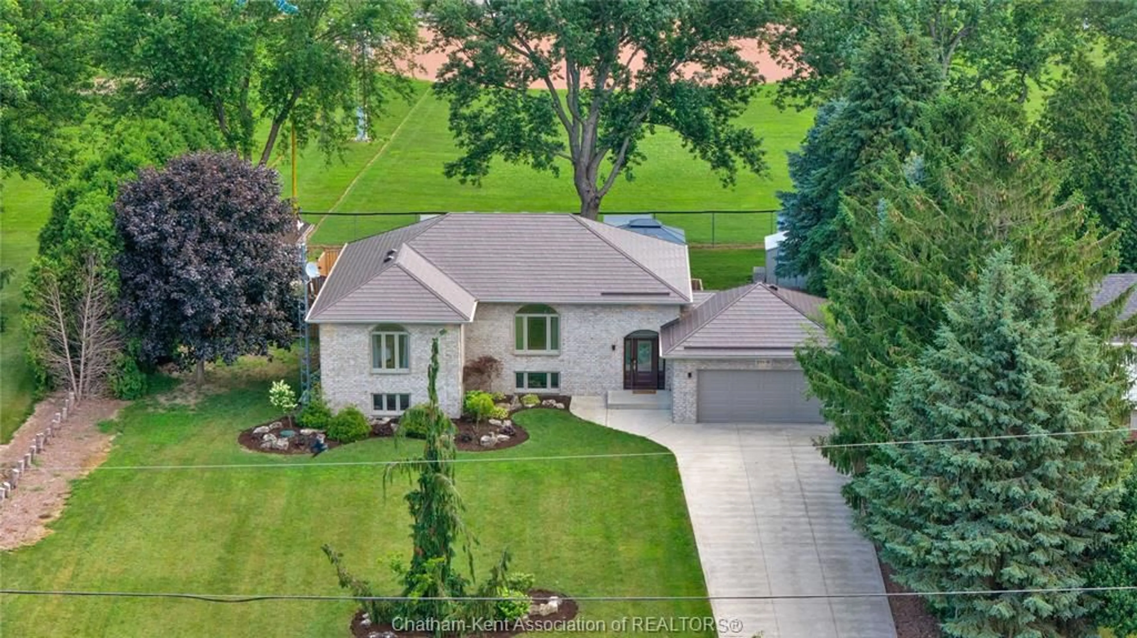 A pic from outside/outdoor area/front of a property/back of a property/a pic from drone, street for 25619 Meadowbrook Lane, Chatham-Kent Ontario N0P 1S0