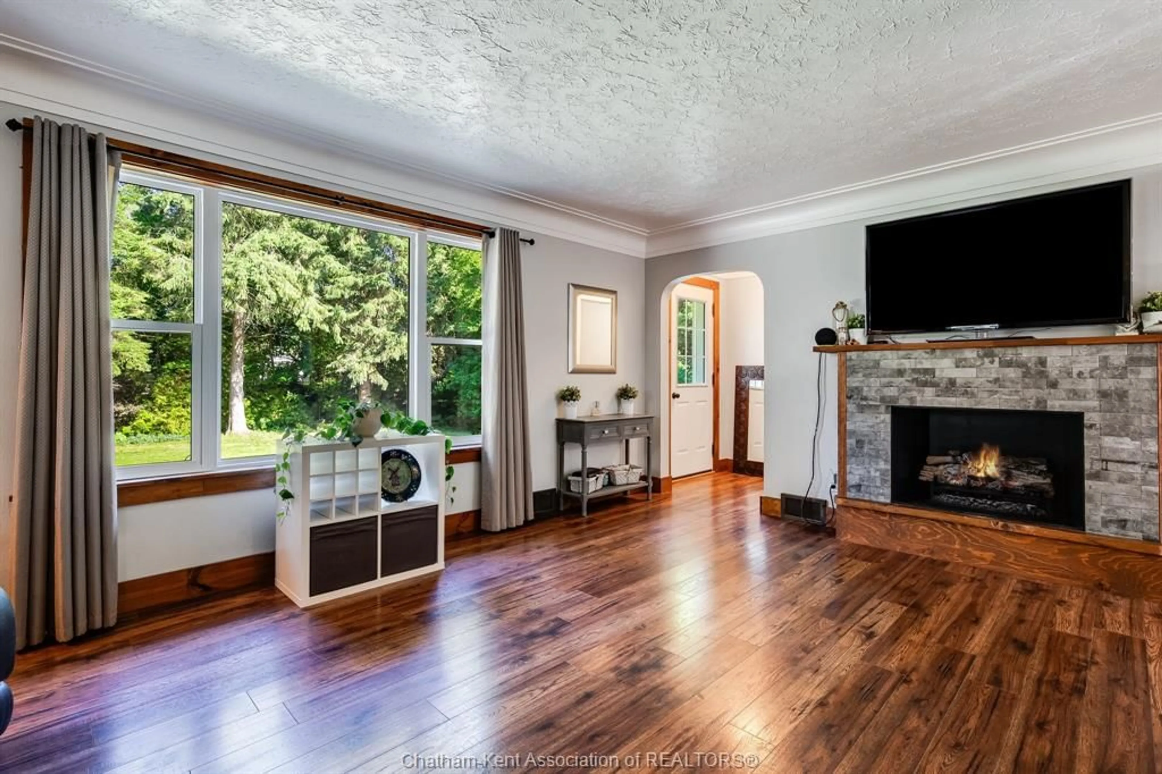 Living room with furniture, wood/laminate floor for 19403 Lagoon Rd, Blenheim Ontario N0P 1A0