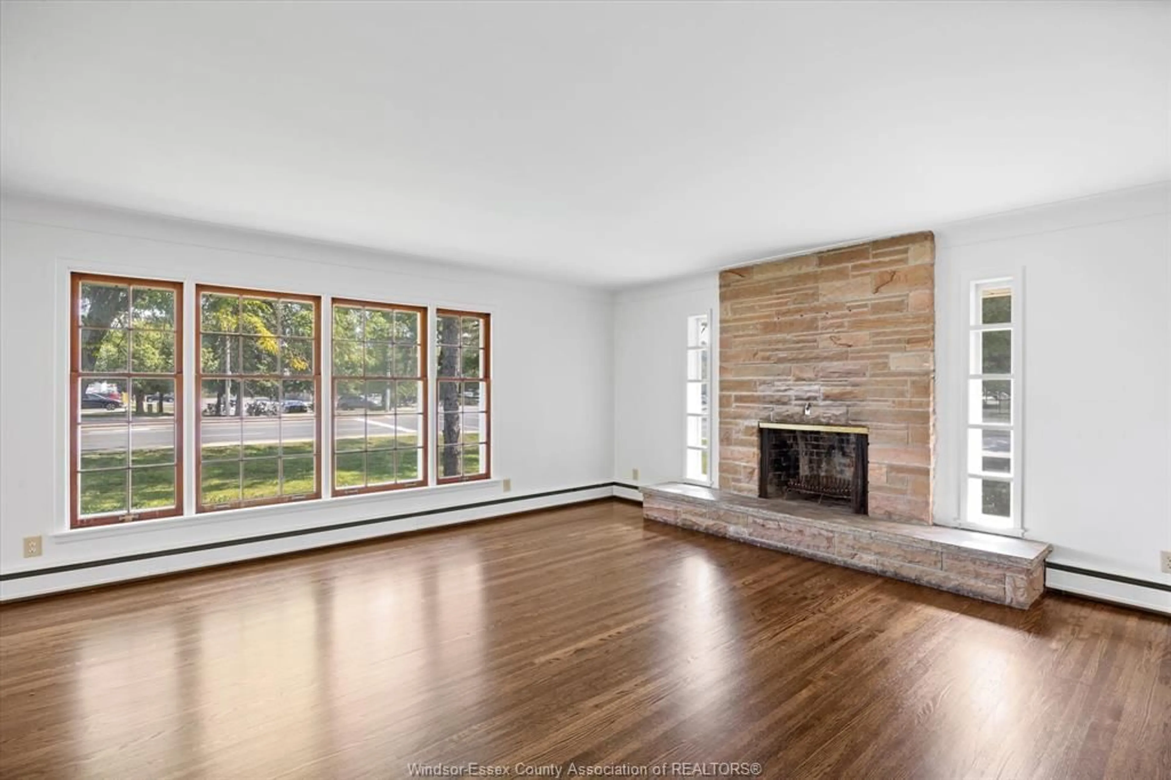 Living room with furniture, wood/laminate floor for 3985 DOUGALL AVE., Windsor Ontario N9G 1X3