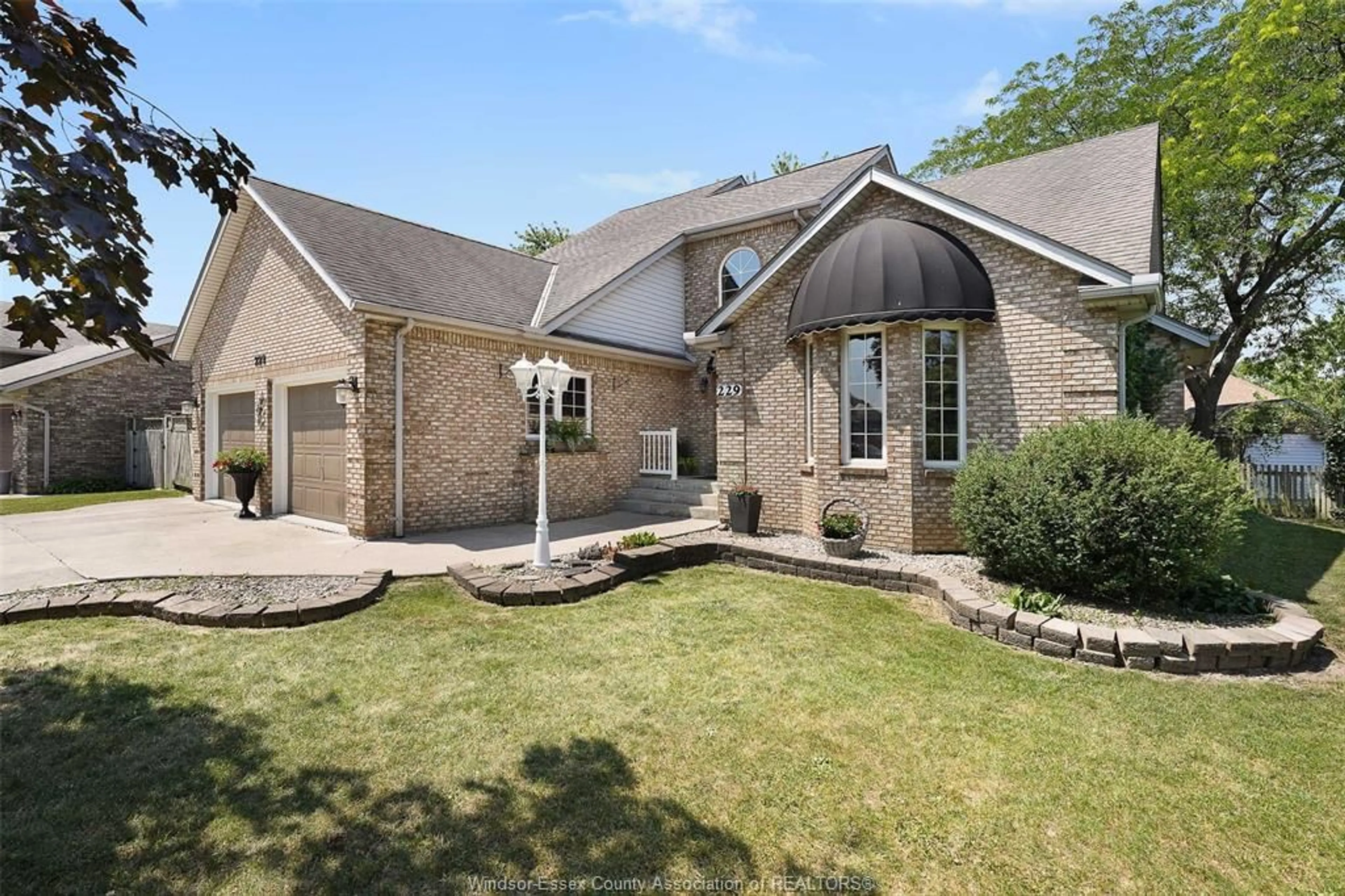 Home with brick exterior material, street for 229 GREENWOOD Cres, Lakeshore Ontario N0R 1A0