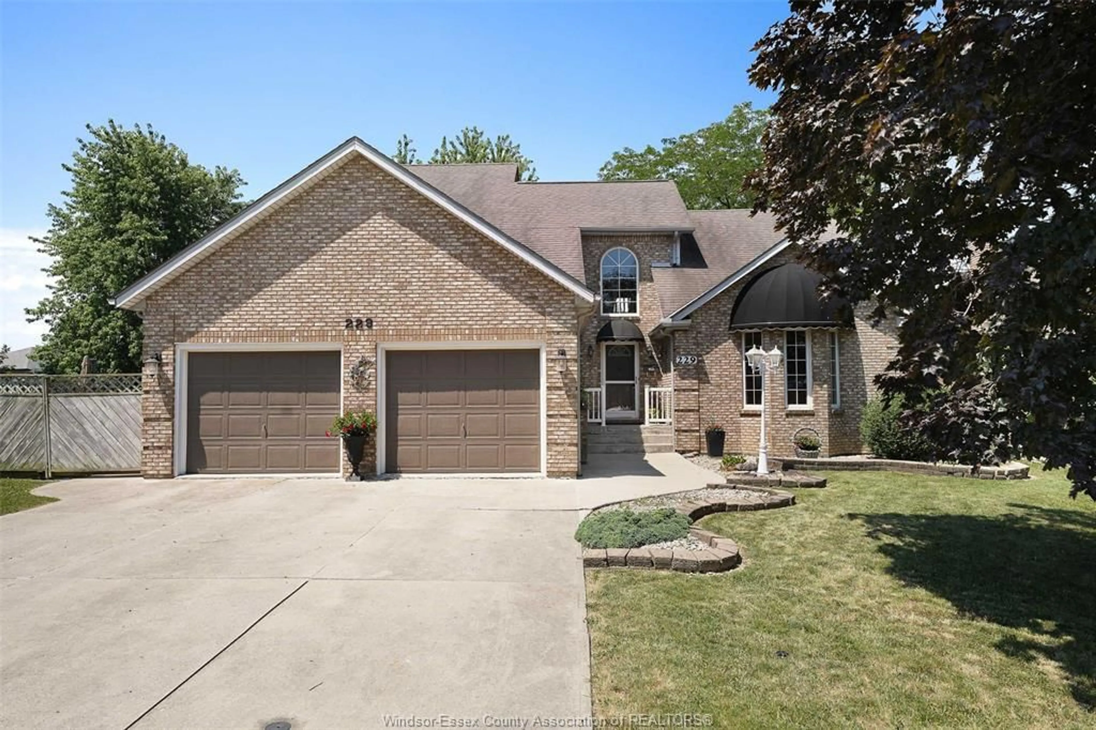 Home with brick exterior material, street for 229 GREENWOOD Cres, Lakeshore Ontario N0R 1A0