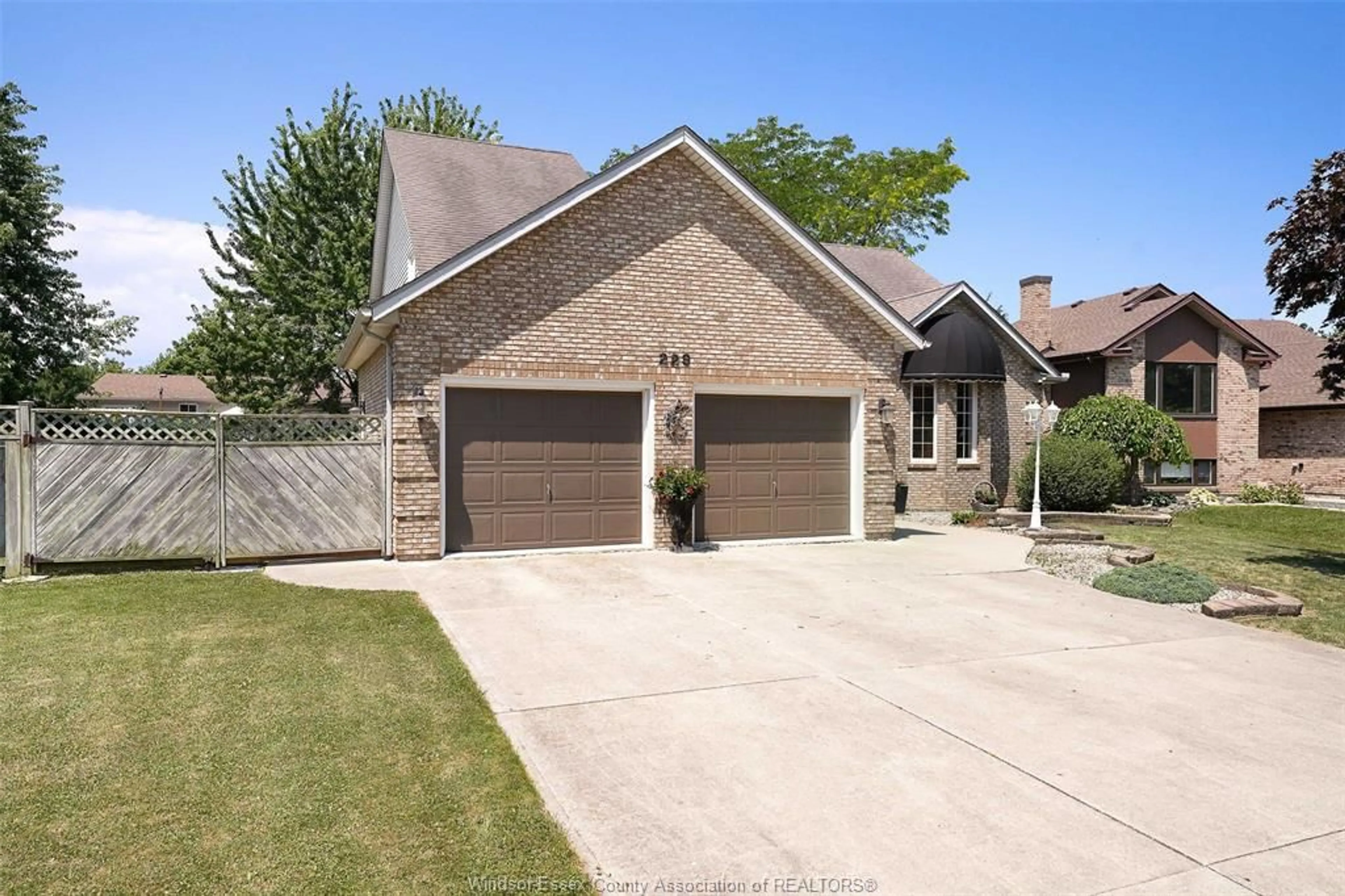 Home with brick exterior material, street for 229 GREENWOOD Cres, Lakeshore Ontario N0R 1A0