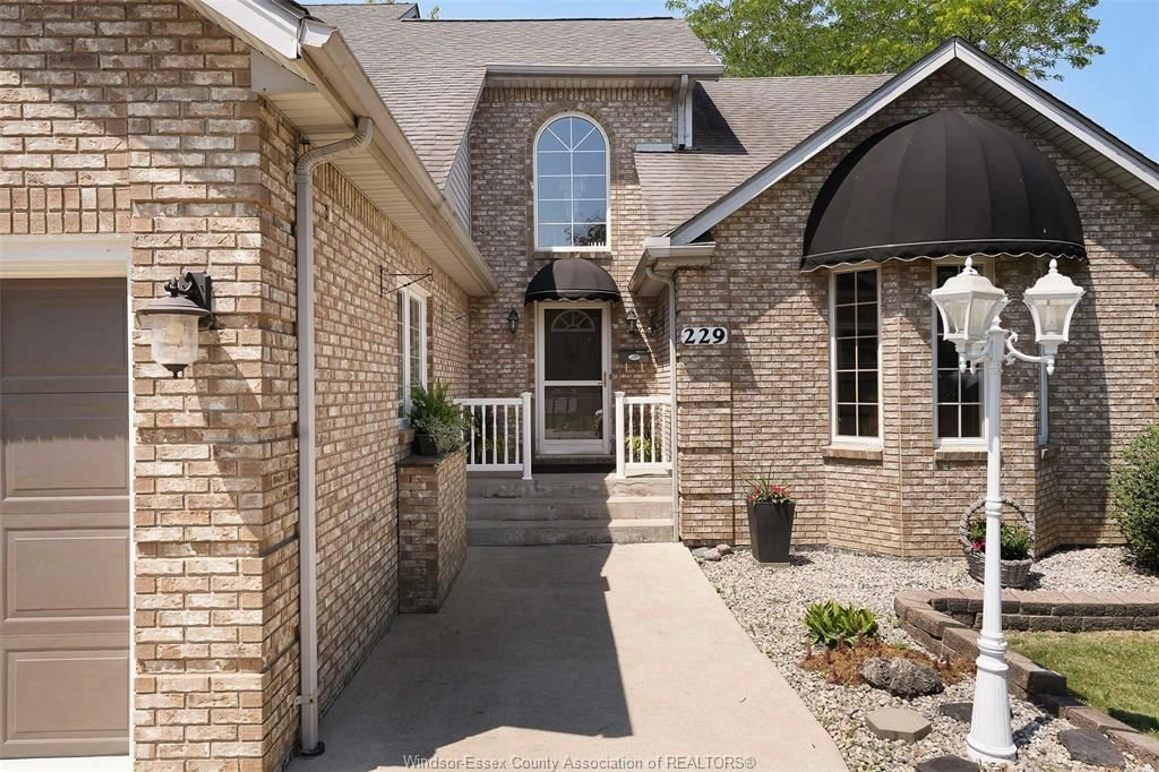 Home with brick exterior material, street for 229 GREENWOOD Cres, Lakeshore Ontario N0R 1A0