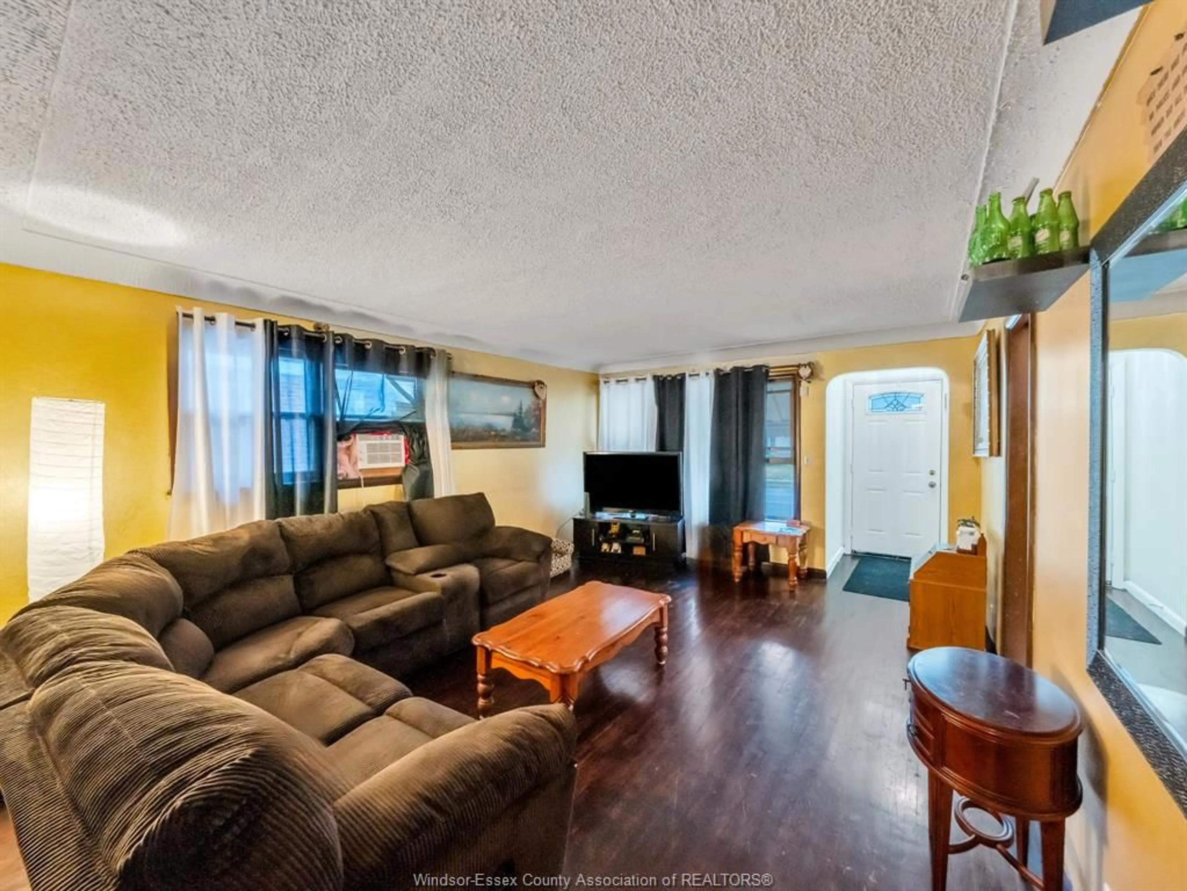 Living room with furniture, wood/laminate floor for 1524 PILLETTE Rd, Windsor Ontario N8Y 3C2