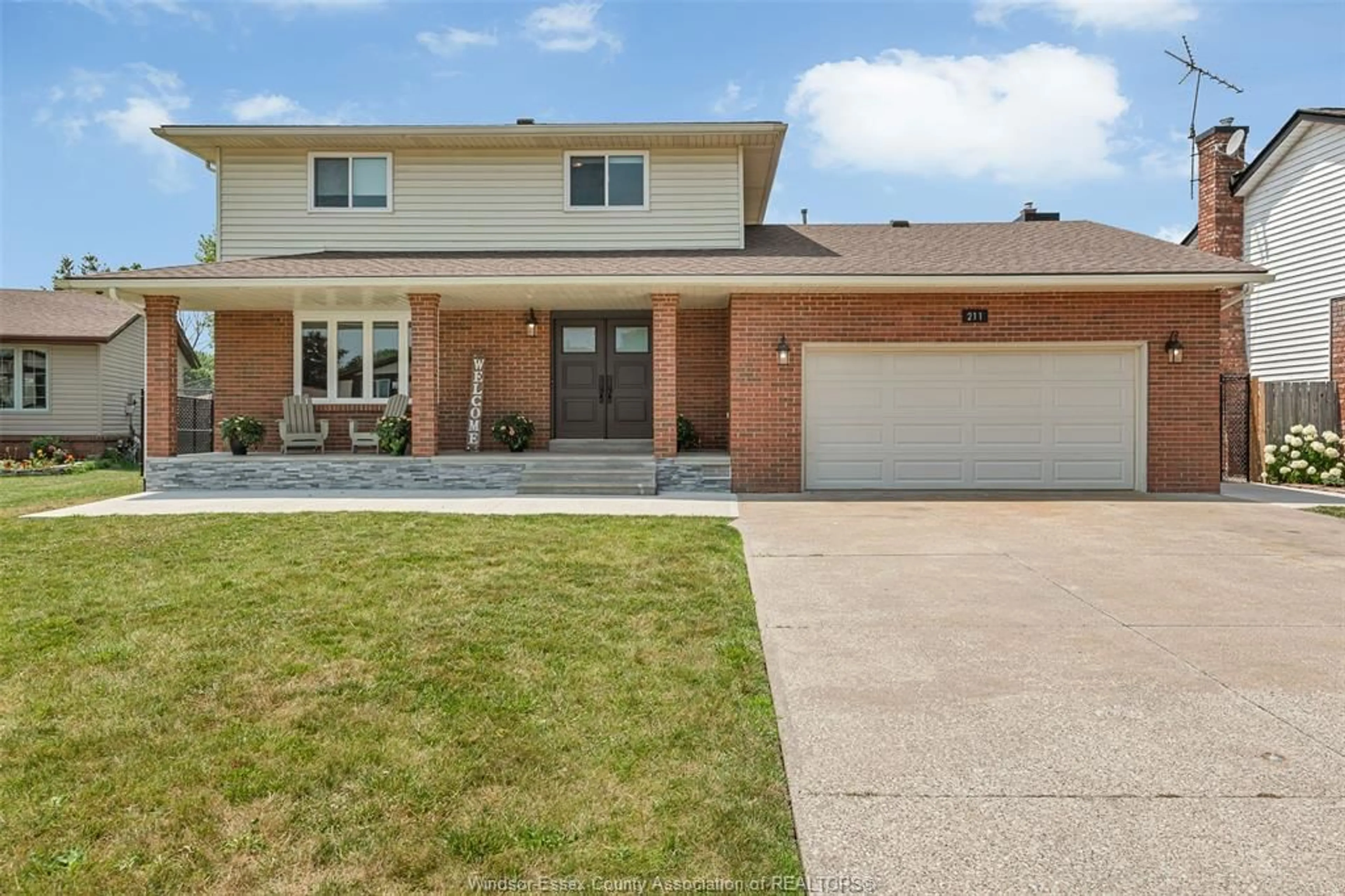 Home with brick exterior material, street for 211 WEDGEWOOD Lane, Tecumseh Ontario N8N 4J4