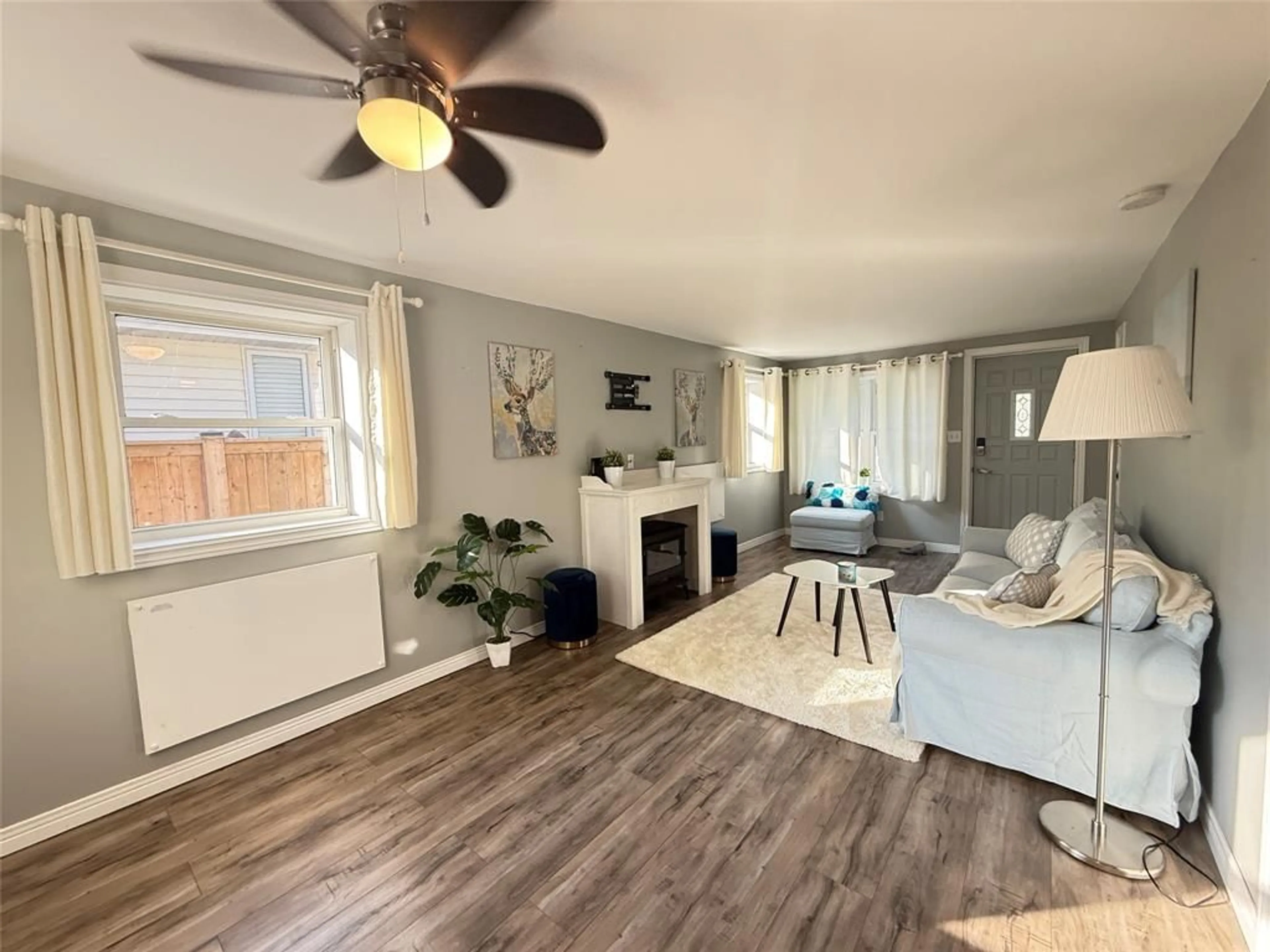 Living room with furniture, wood/laminate floor for 7811 KEN St, Plympton-Wyoming Ontario N0N 1J6