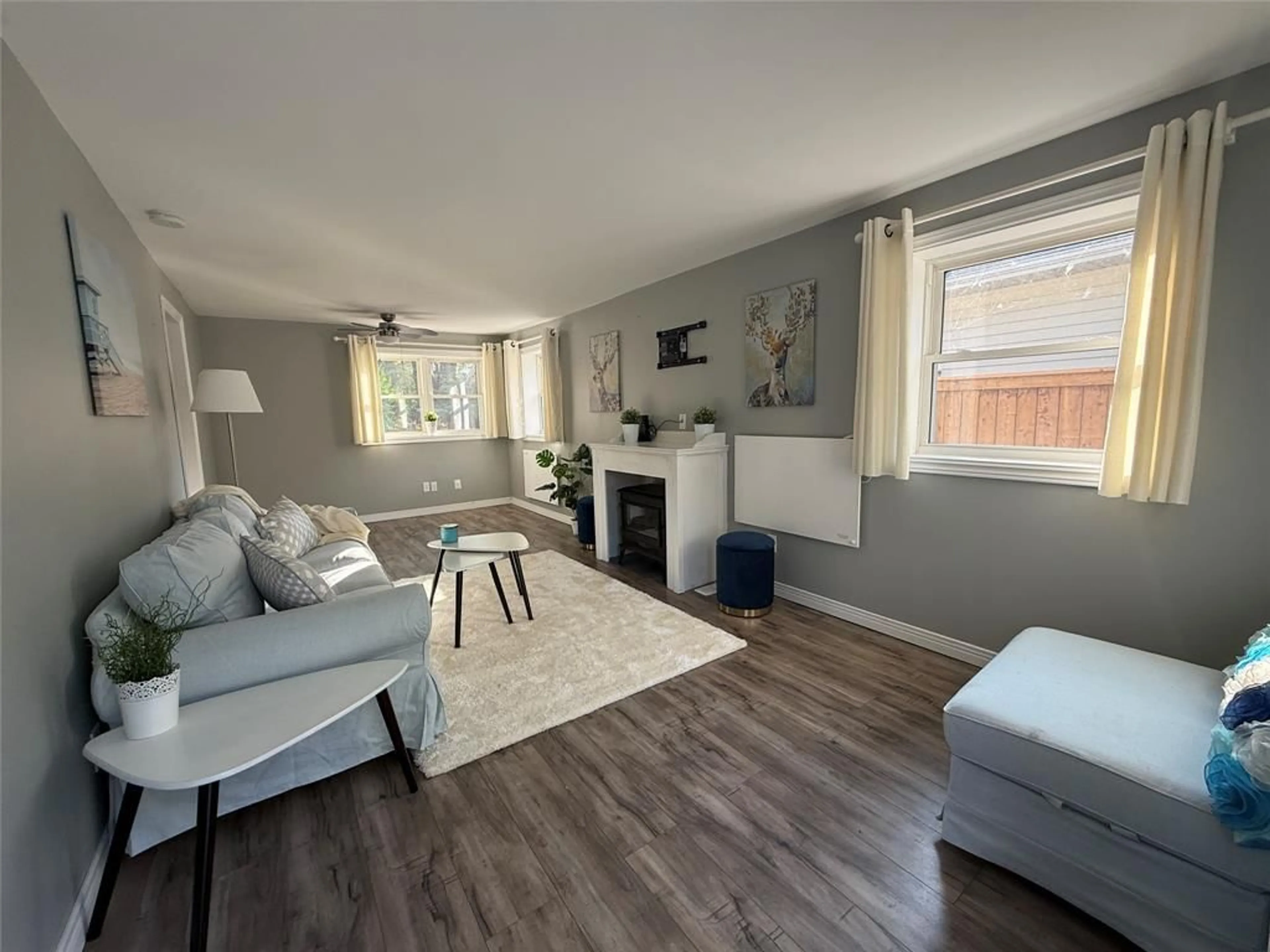 Living room with furniture, wood/laminate floor for 7811 KEN St, Plympton-Wyoming Ontario N0N 1J6