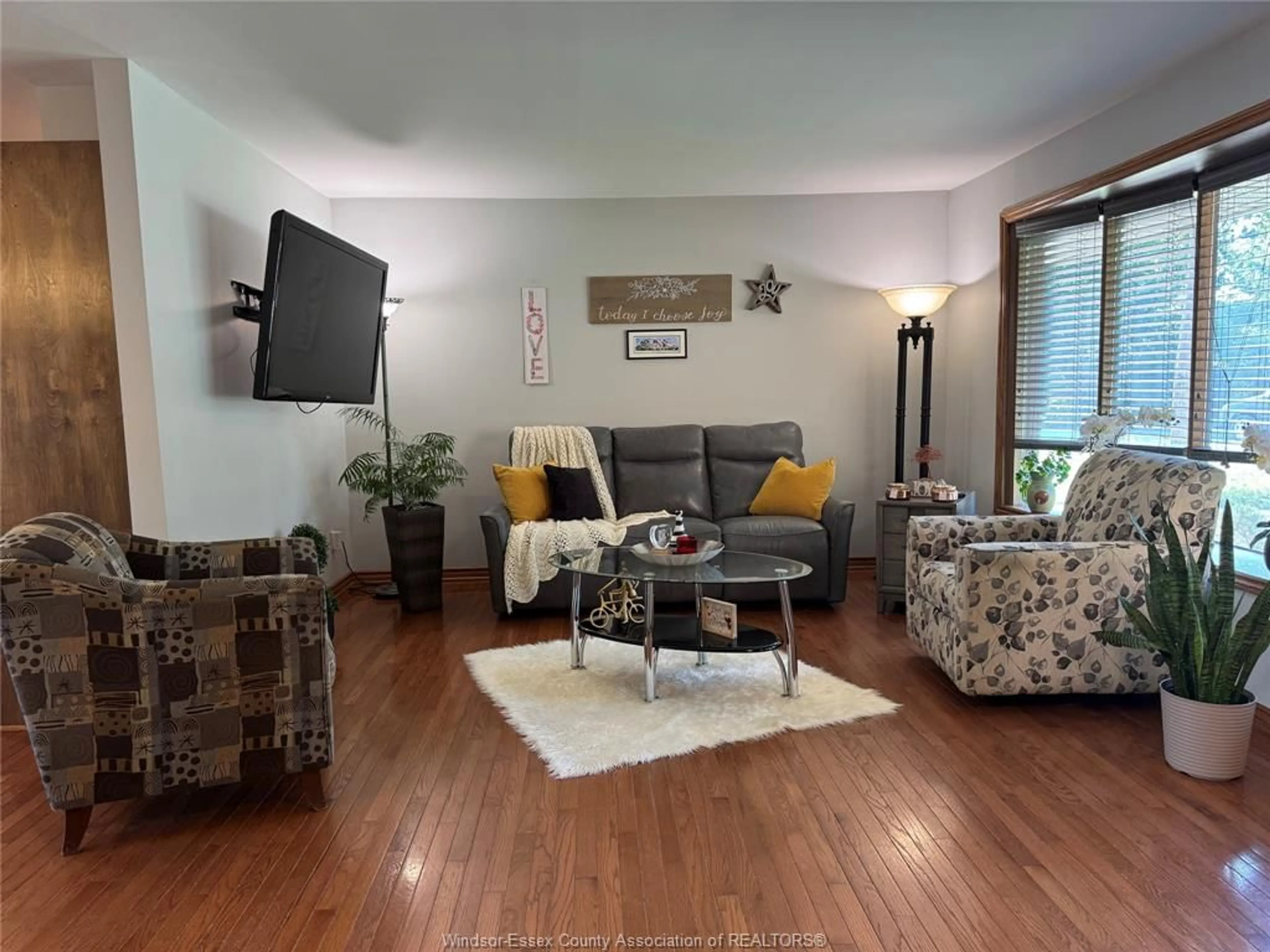 Living room with furniture, wood/laminate floor for 353 Cousineau Rd, Windsor Ontario N9G 1V6