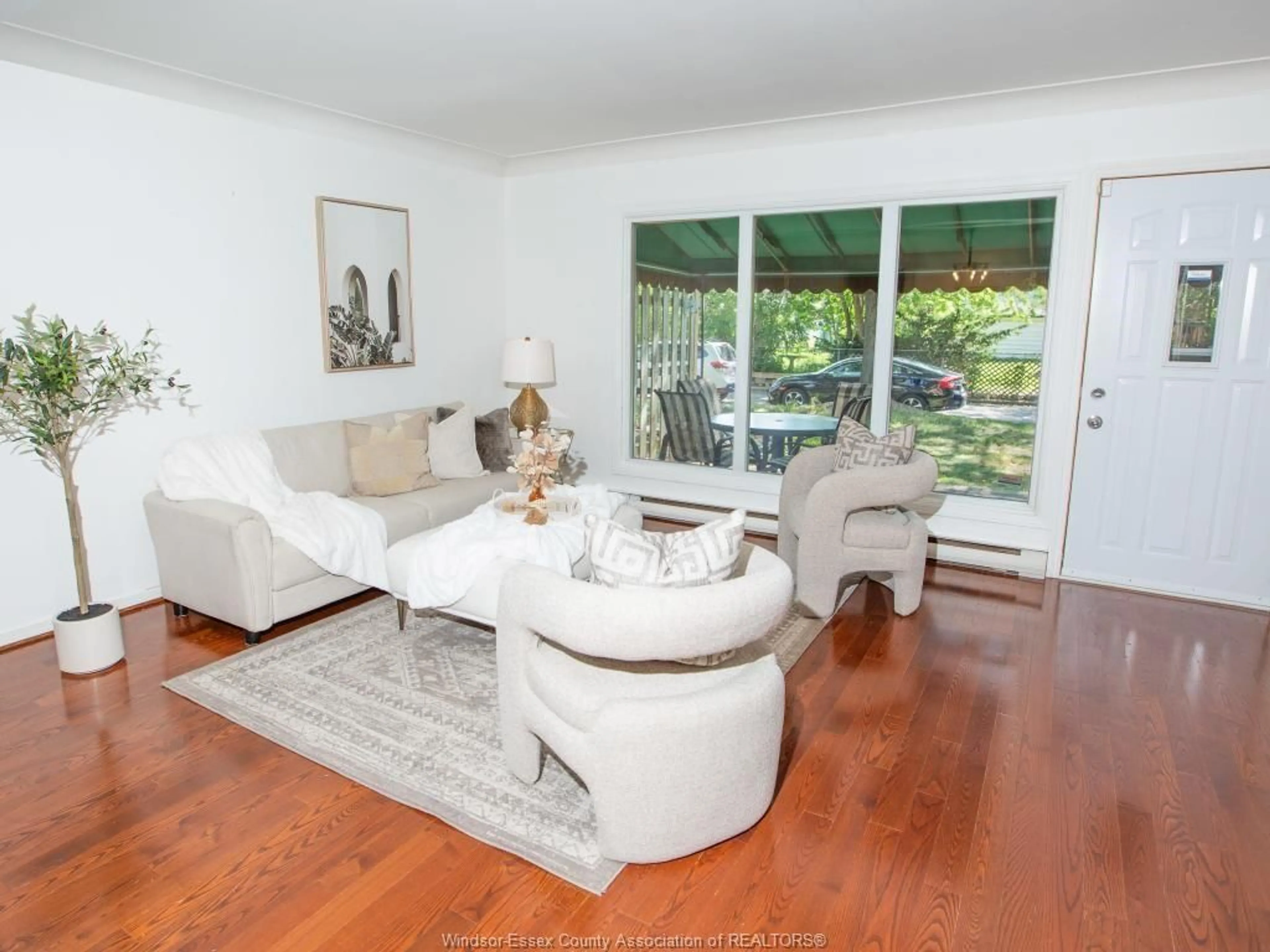 Living room with furniture, wood/laminate floor for 1619 EASTGATE ESTATES #65, Windsor Ontario N8T 2S8