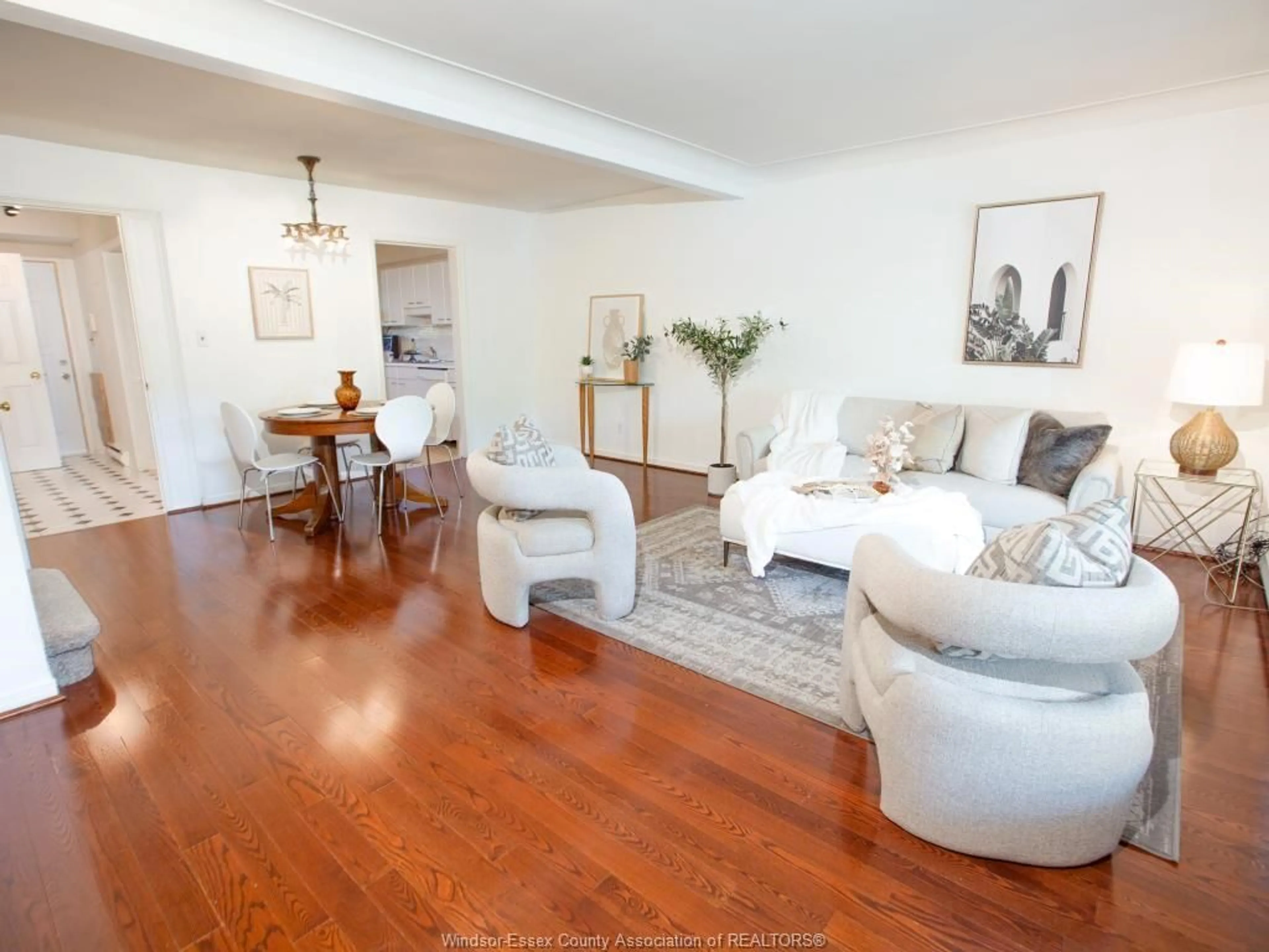 Living room with furniture, wood/laminate floor for 1619 EASTGATE ESTATES #65, Windsor Ontario N8T 2S8