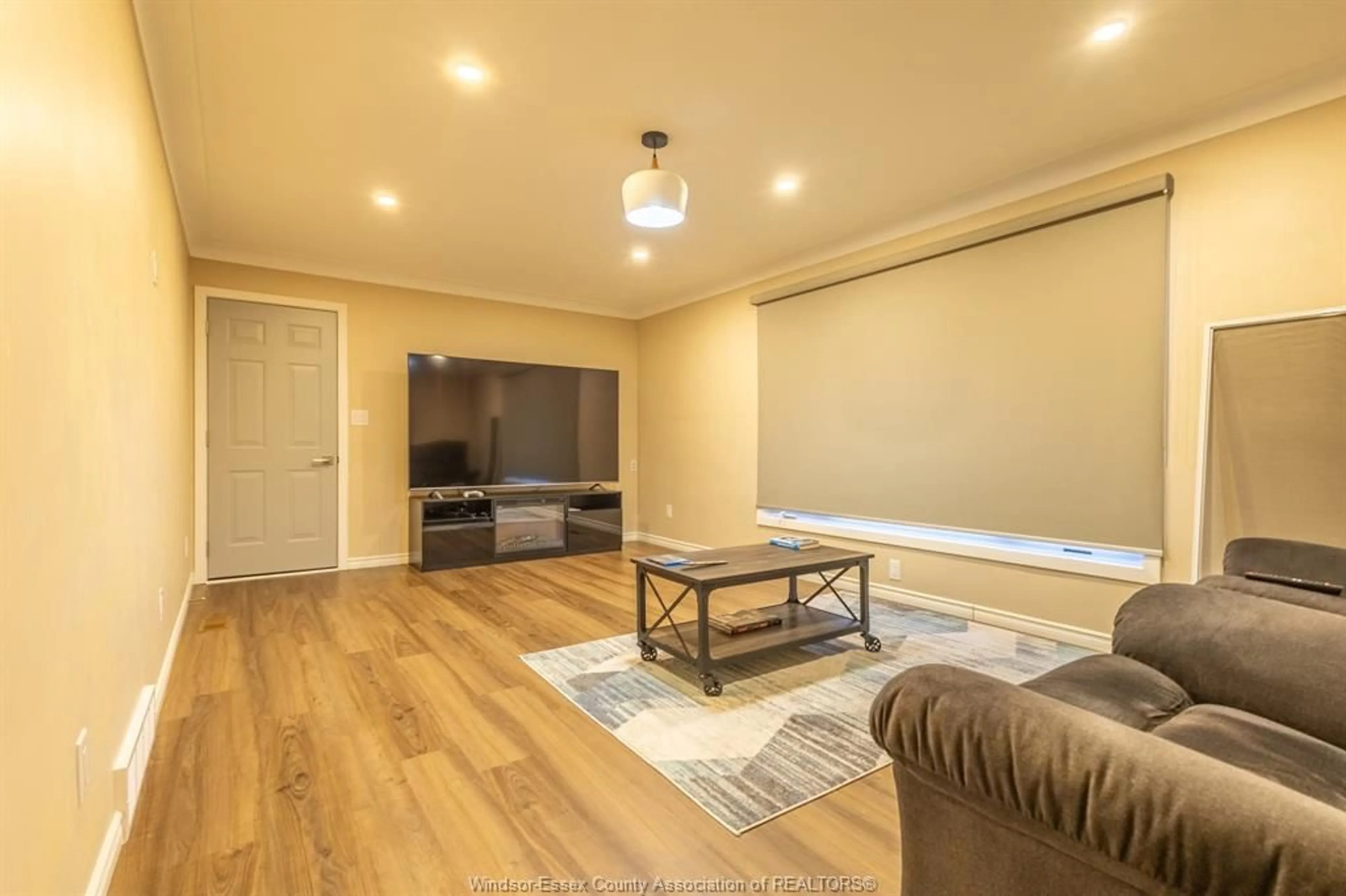 Living room with furniture, wood/laminate floor for 1695 DIVISION Rd, Kingsville Ontario N9Y 2Y9
