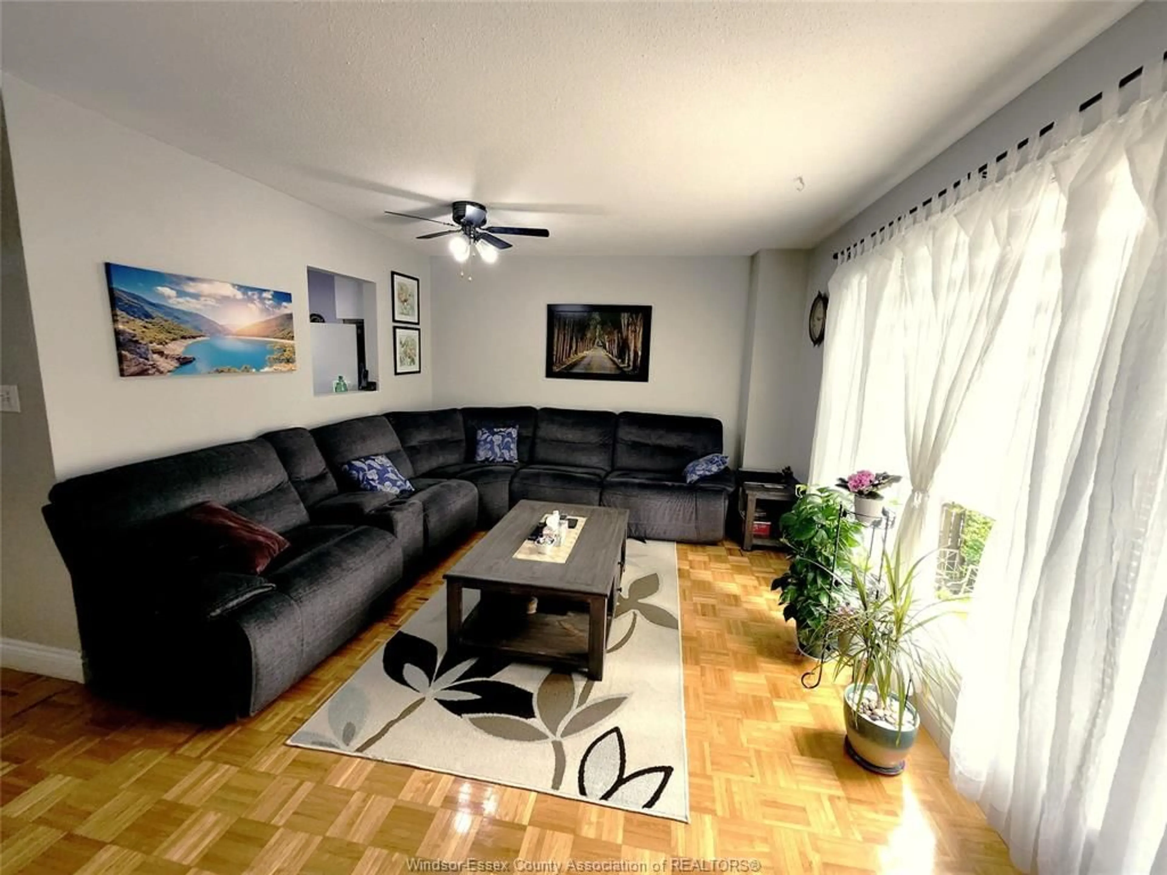 Living room with furniture, wood/laminate floor for 6374 THORNBERRY #444, Windsor Ontario N8T 3A2