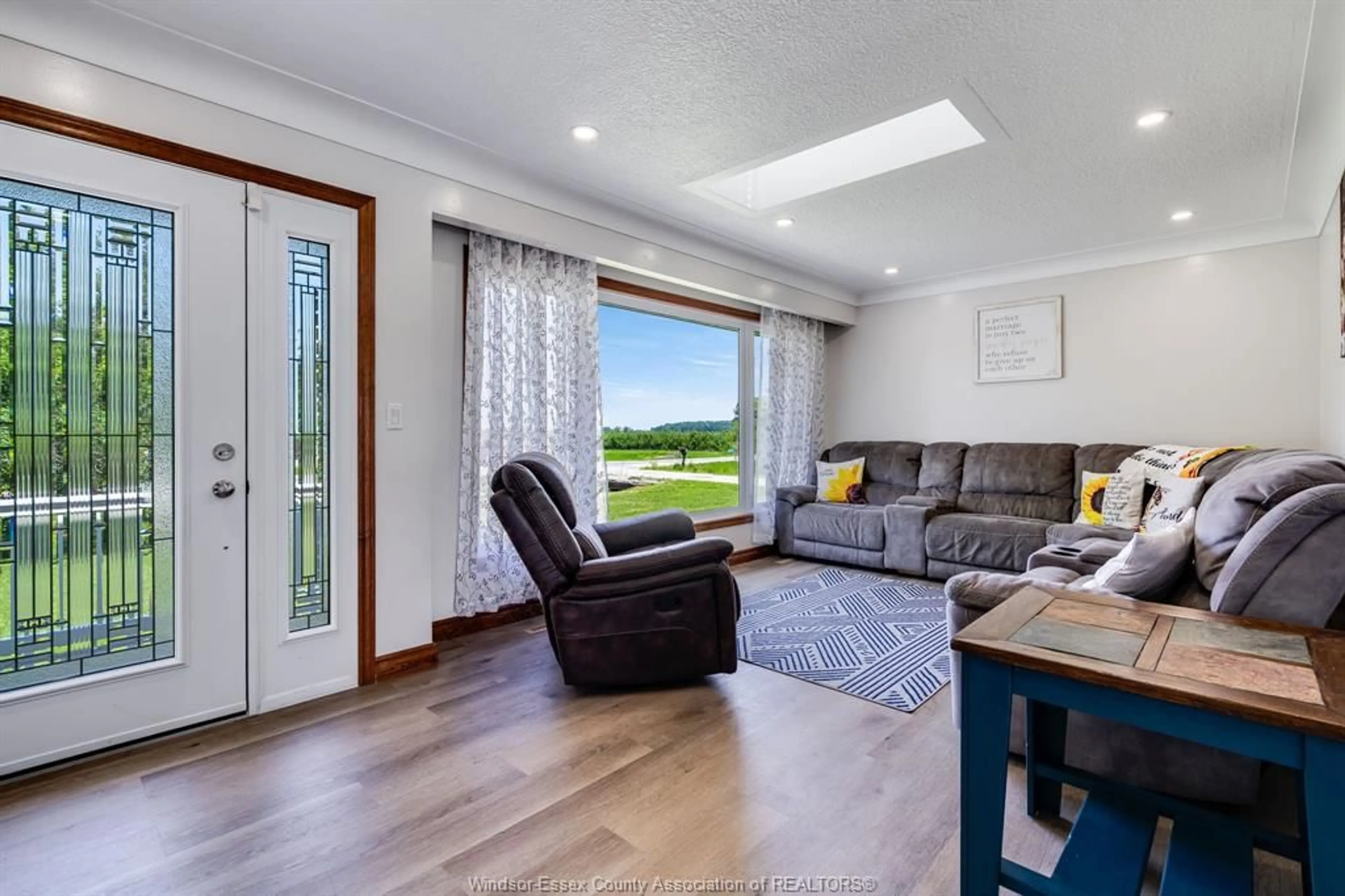 Living room with furniture, wood/laminate floor for 252 Road 7, Ruthven Ontario N0P 2G0