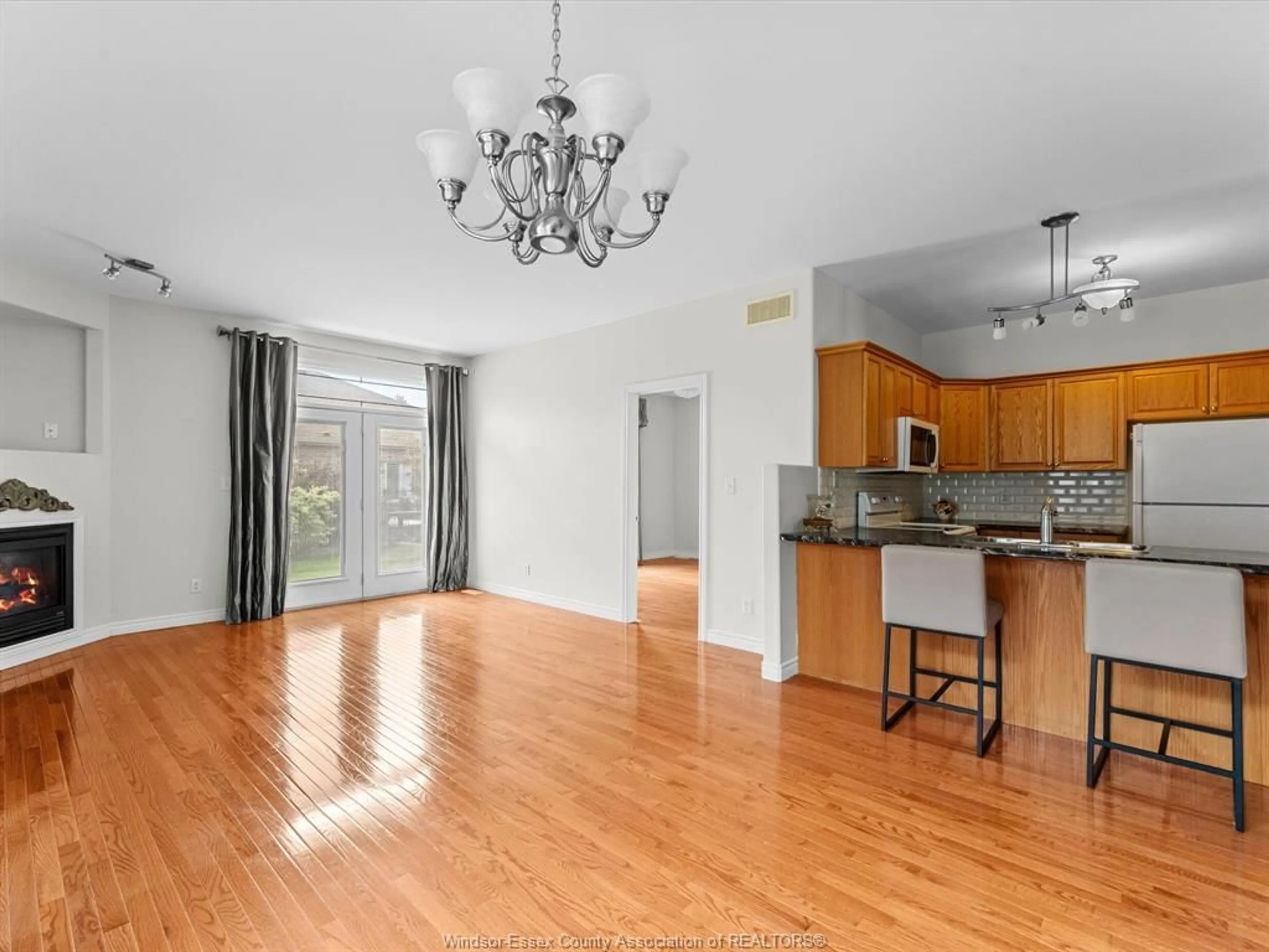 Open concept kitchen, wood/laminate floor for 11841 Blair St, Windsor Ontario N8P 1T4