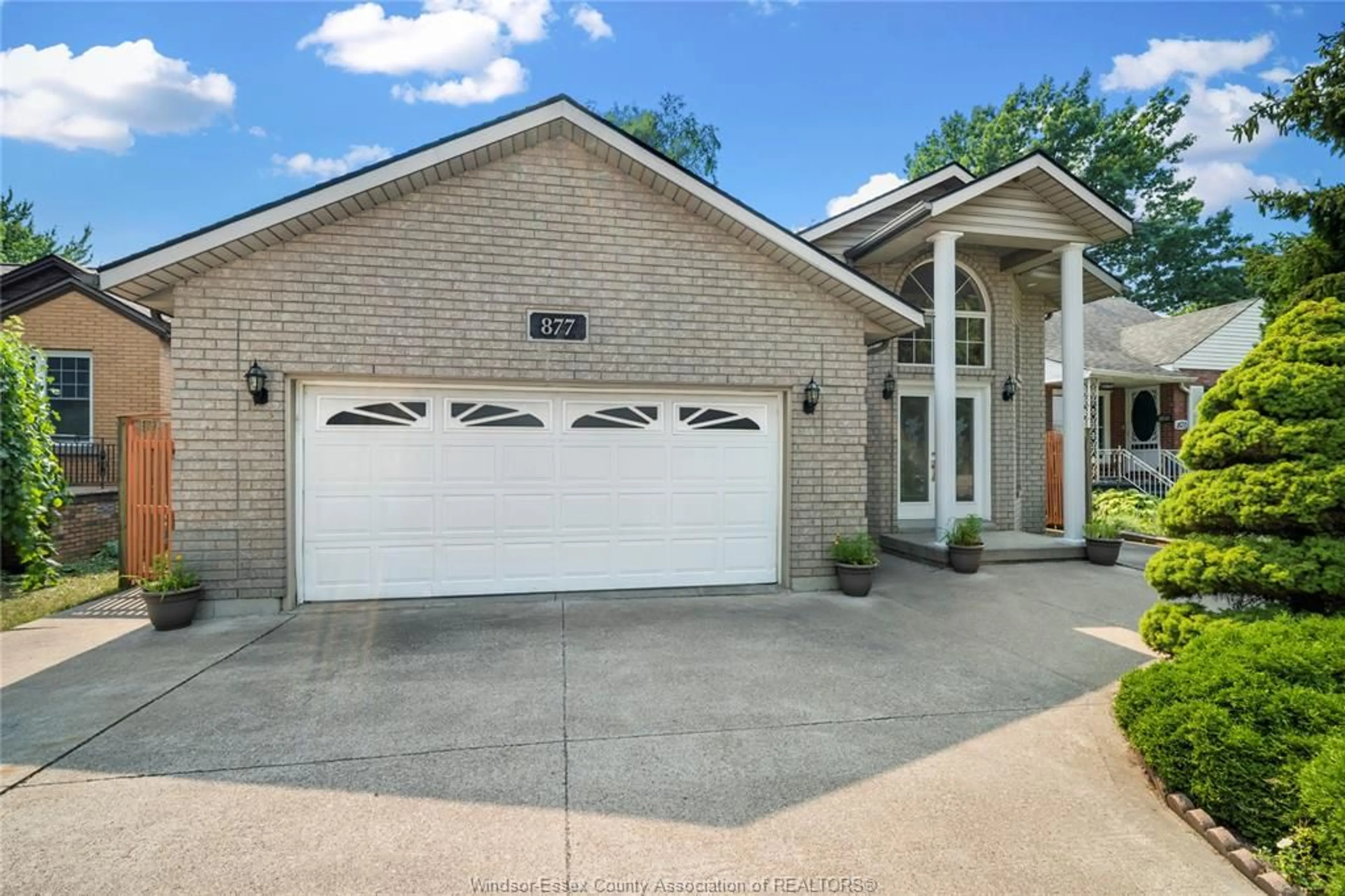Home with brick exterior material, street for 877 LAUZON RD, Windsor Ontario N8S 3M4