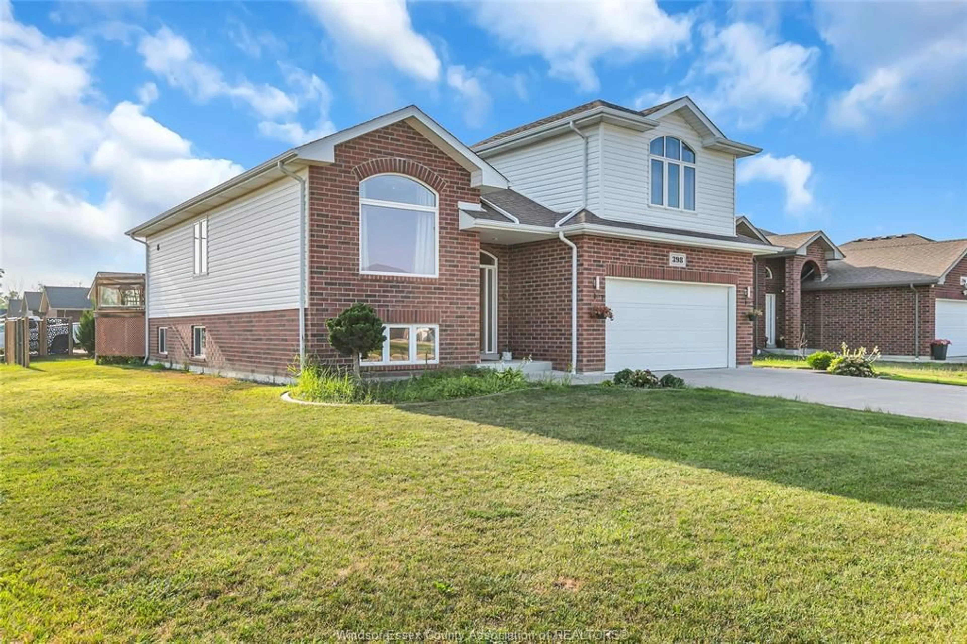 Home with brick exterior material, street for 398 POPLAR Dr, Lakeshore Ontario N0R 1A0