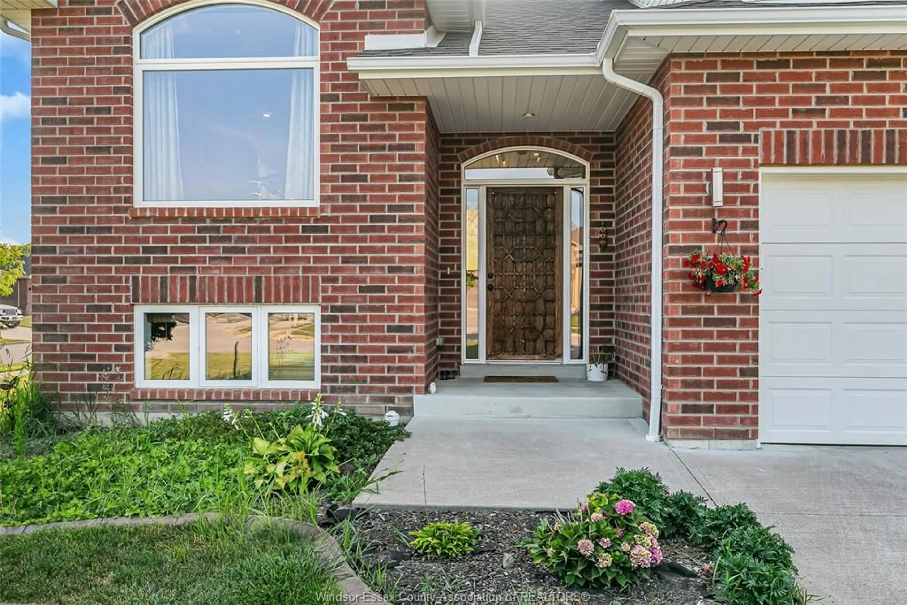 Home with brick exterior material, street for 398 POPLAR Dr, Lakeshore Ontario N0R 1A0
