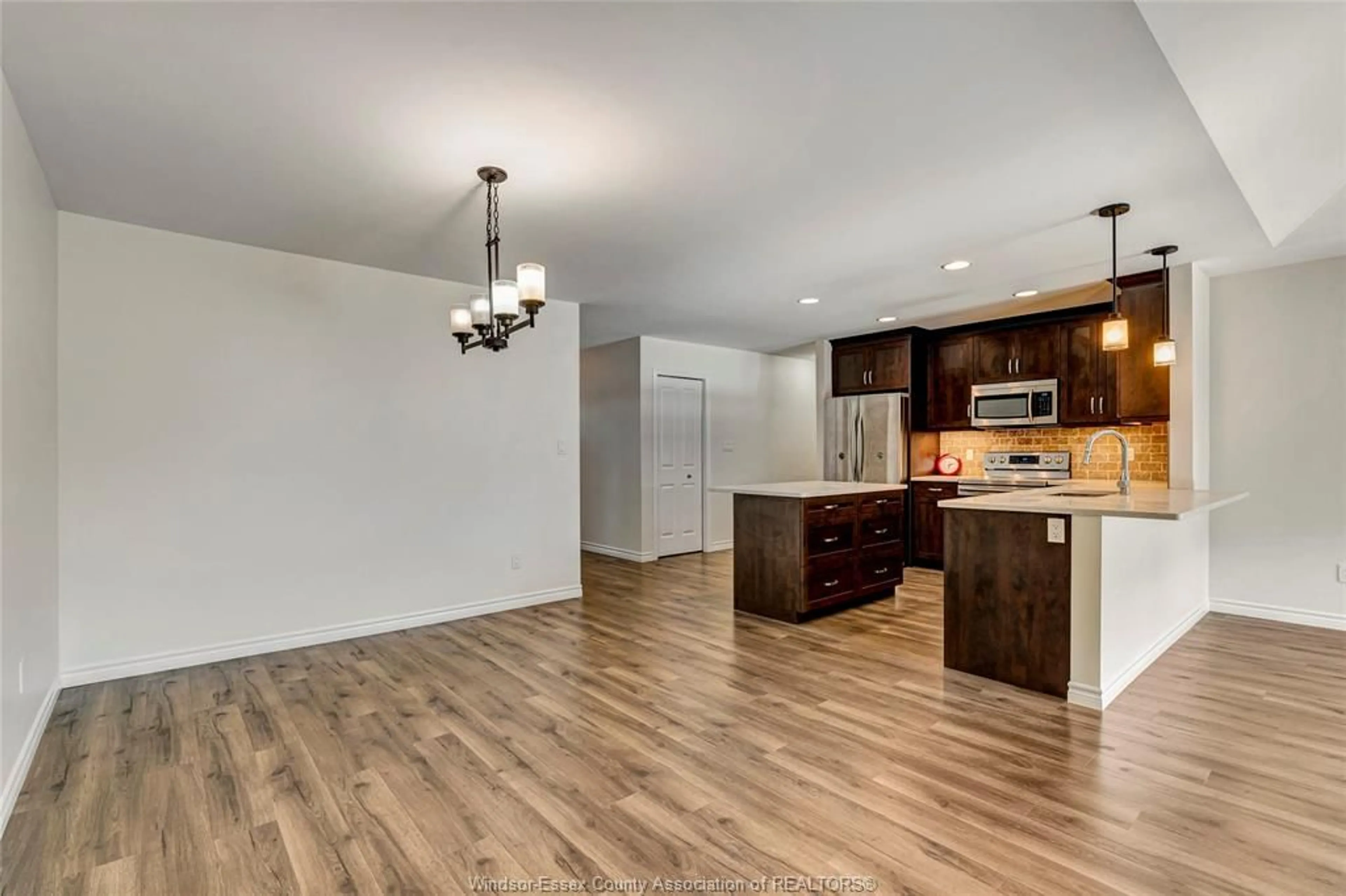 Open concept kitchen, wood/laminate floor for 1171 BRIDAL FALLS Cres, Windsor Ontario N8P 0C5