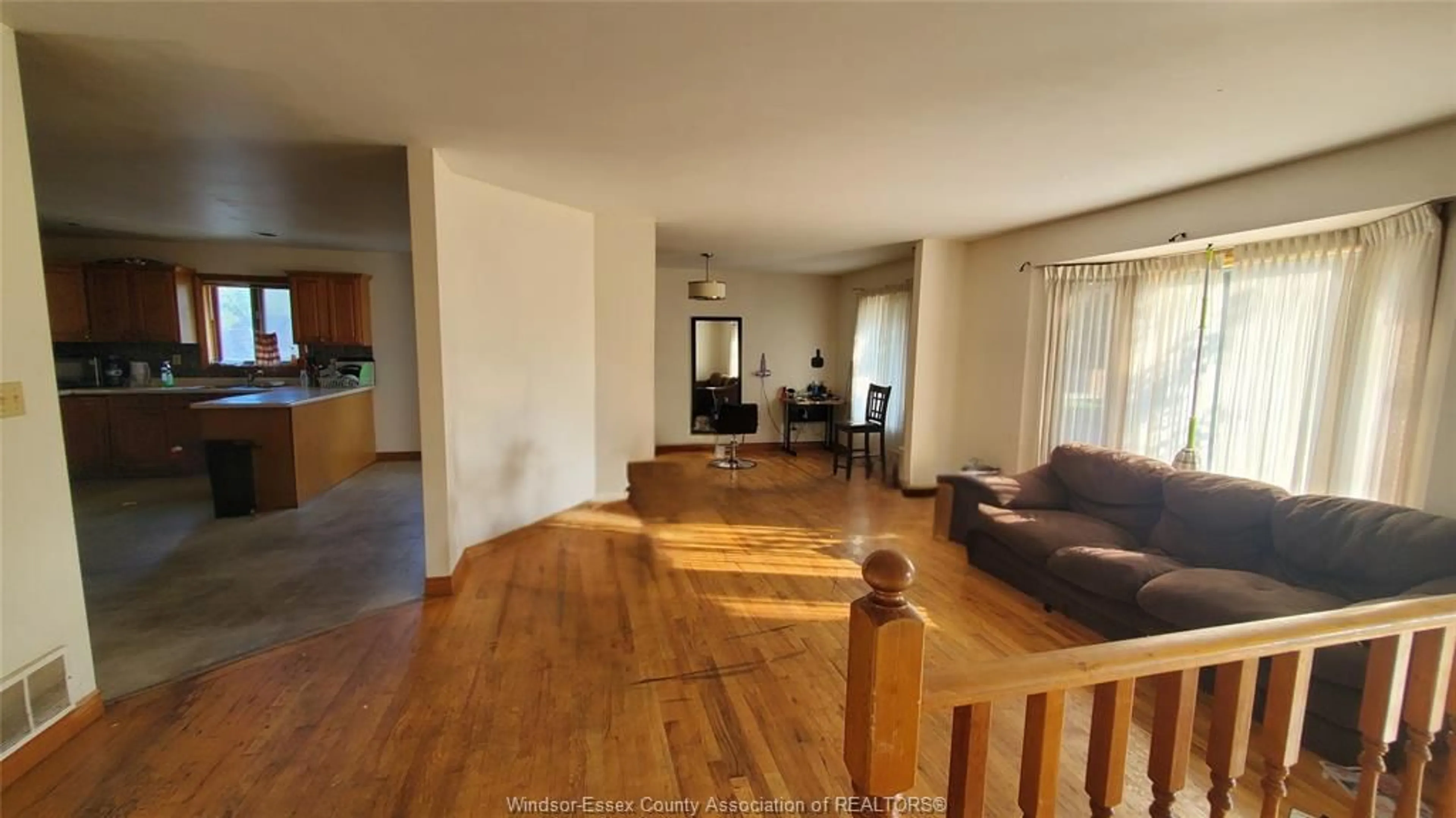 Living room with furniture, wood/laminate floor for 1995 GRAND MARAIS Rd, Windsor Ontario N9E 1E9