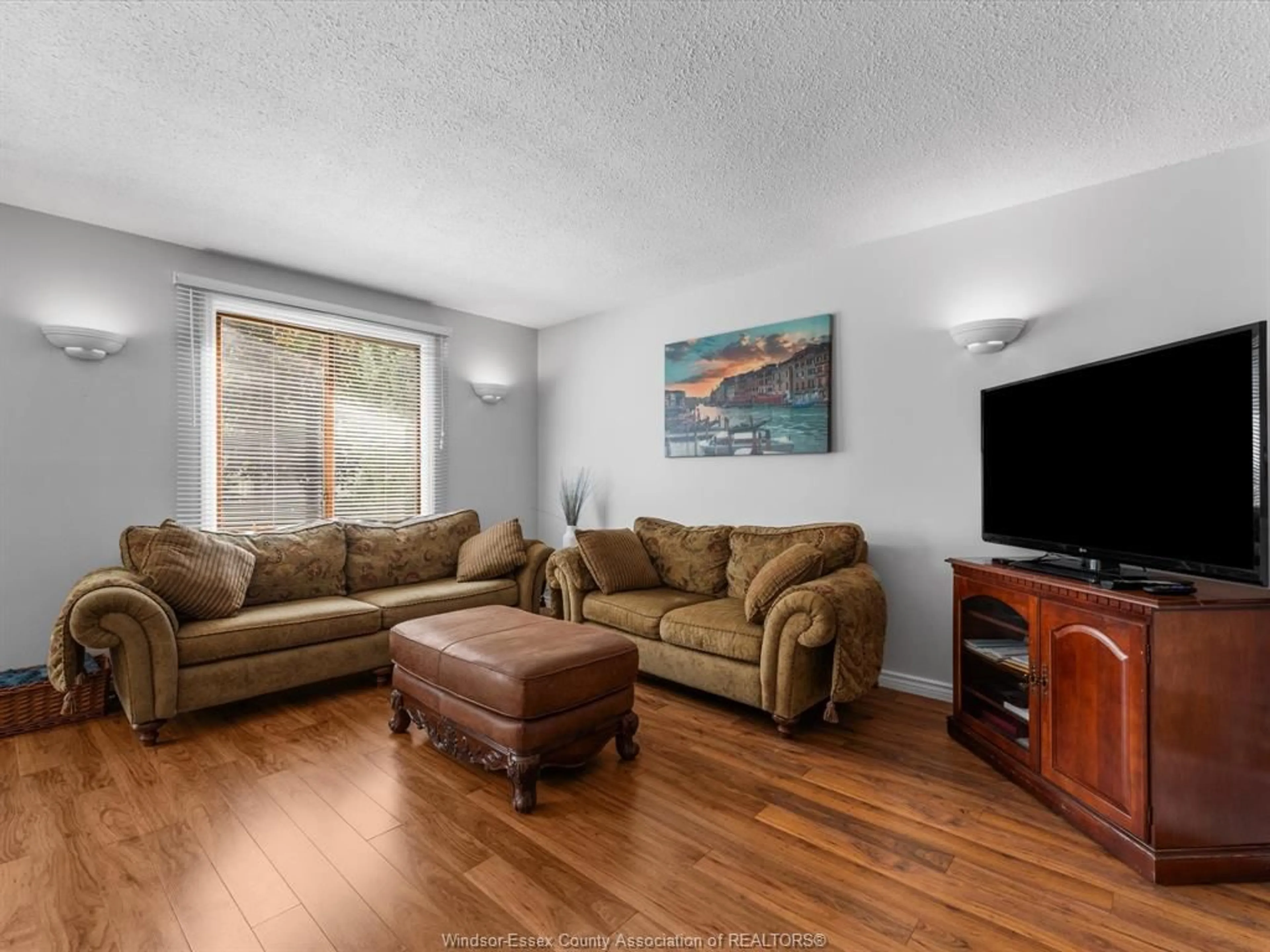 Living room with furniture, wood/laminate floor for 3834 Montcalm St, Windsor Ontario N9E 2A9