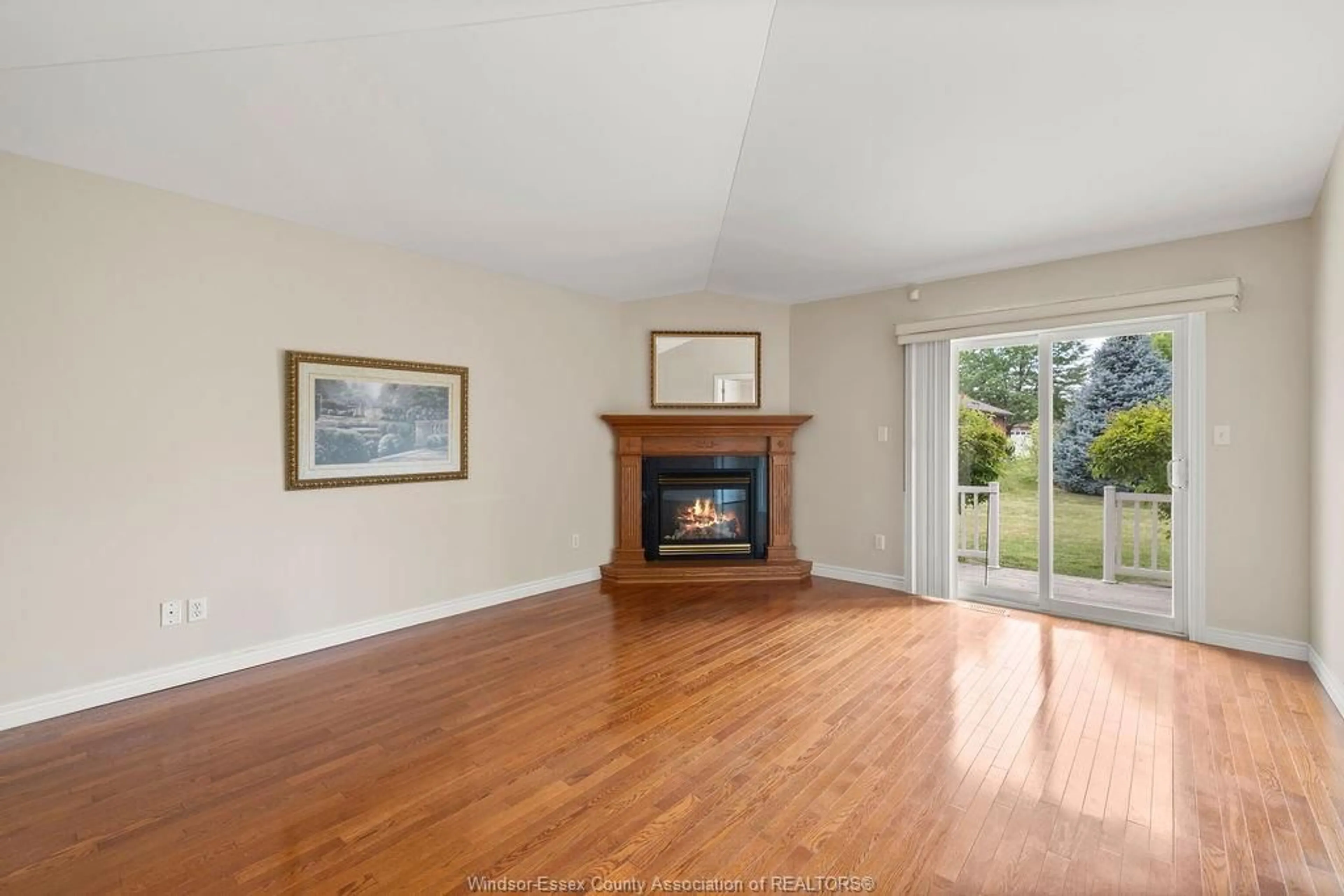 Living room with furniture, wood/laminate floor for 2091 QUESTA, Windsor Ontario N8P 1N8