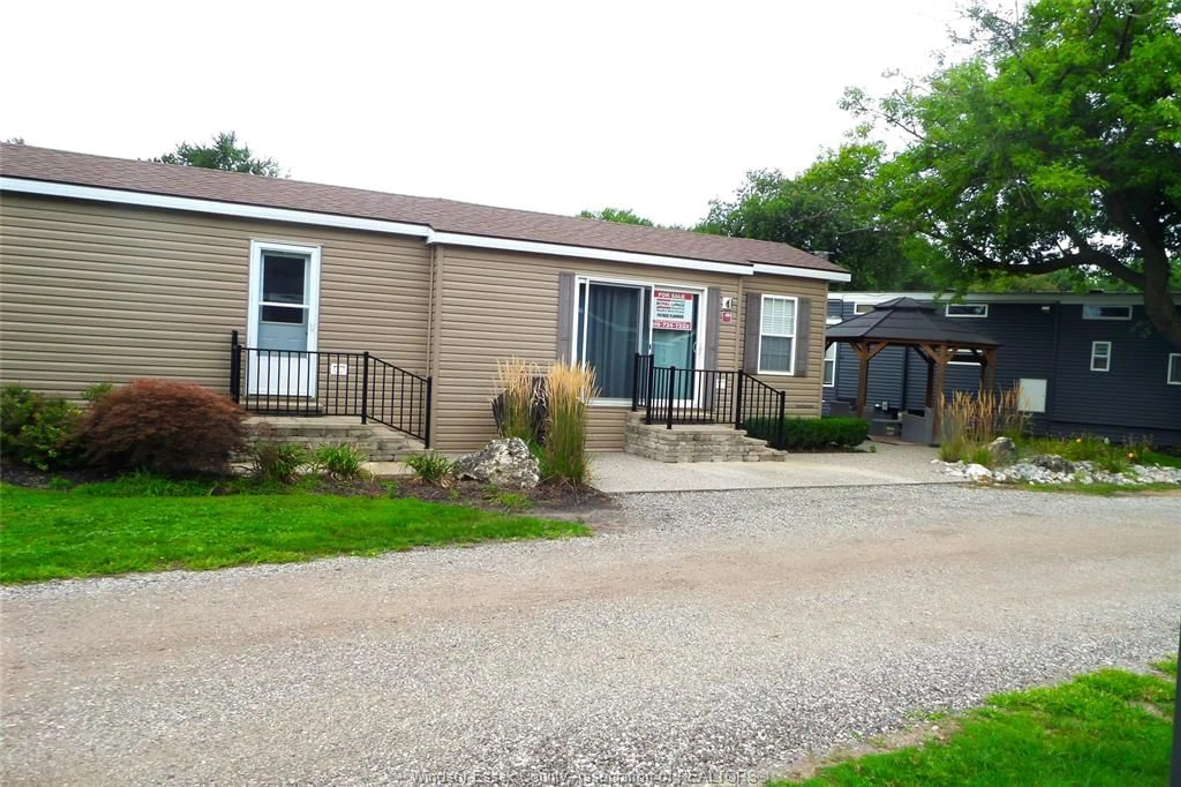 A pic from outside/outdoor area/front of a property/back of a property/a pic from drone, street for 981 COUNTY RD 2 #700, Lakeshore Ontario N8L 1B4