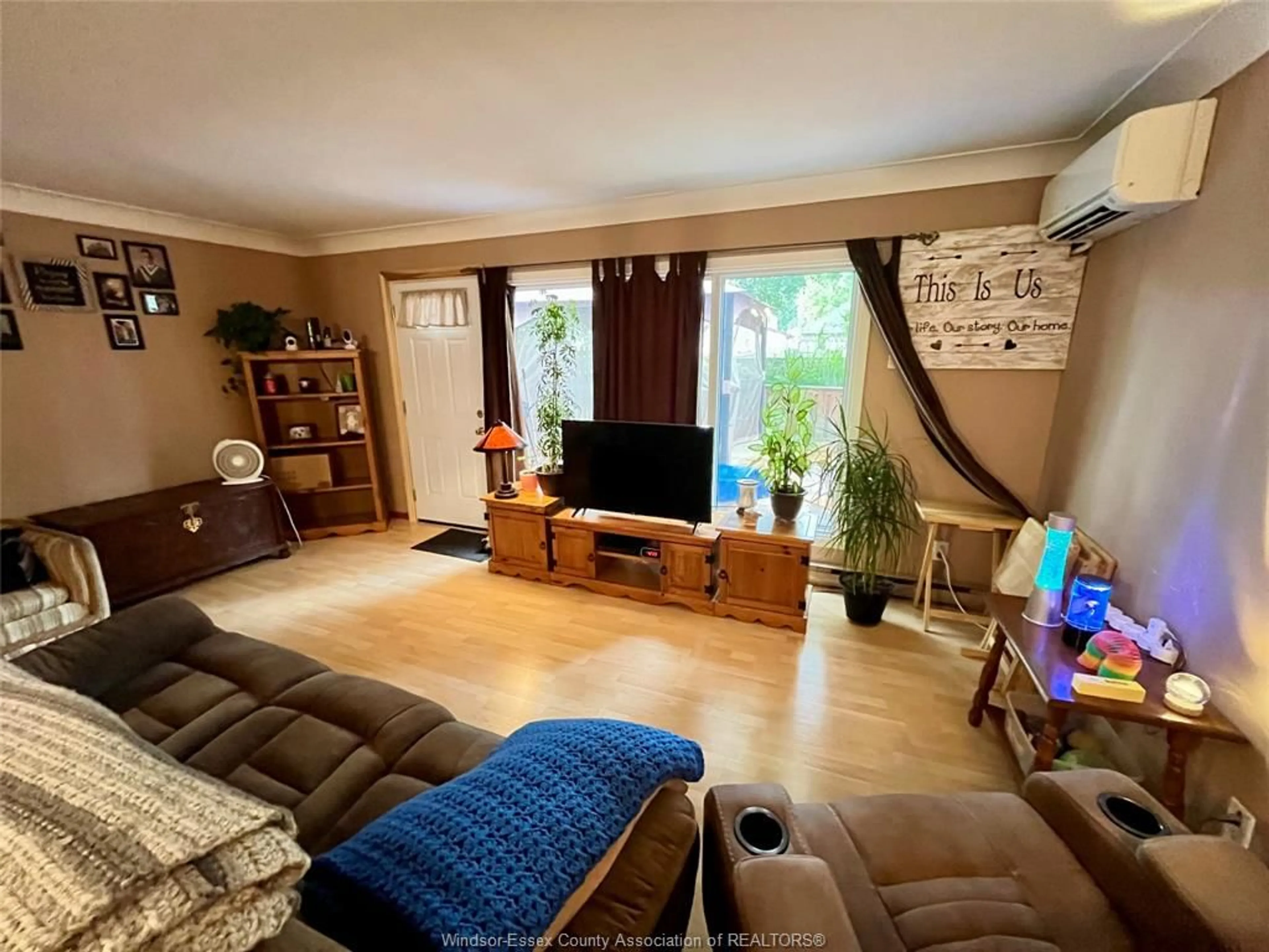 Living room with furniture, wood/laminate floor for 1681 EASTGATE ESTATES #52, Windsor Ontario N8T 2S5