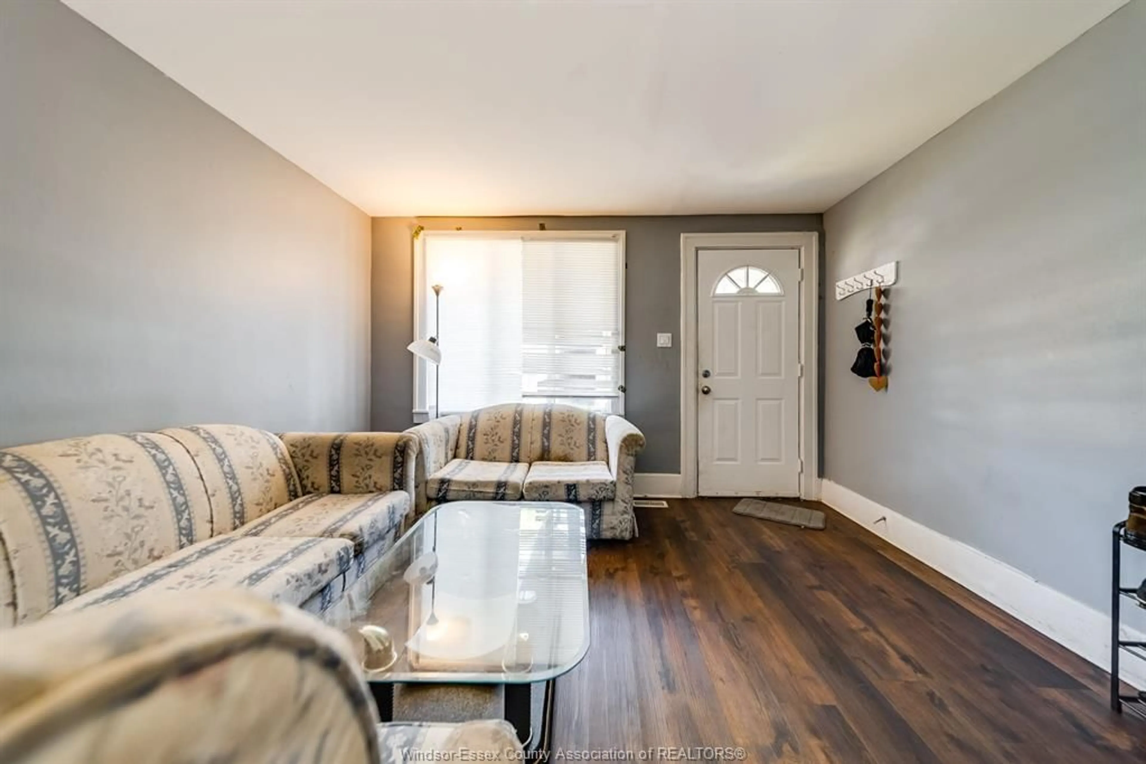 Living room with furniture, wood/laminate floor for 961 CURRY Ave, Windsor Ontario N9B 2C4