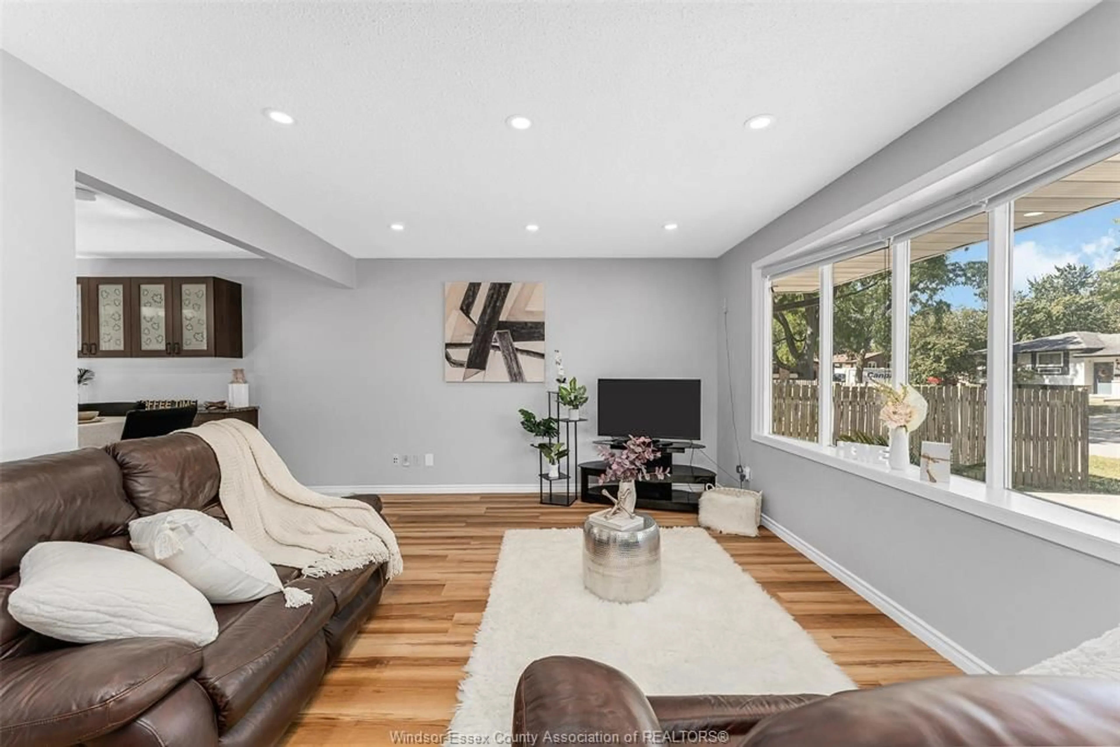 Living room with furniture, wood/laminate floor for 9982 KENWOOD Cres, Windsor Ontario N8R 1H2