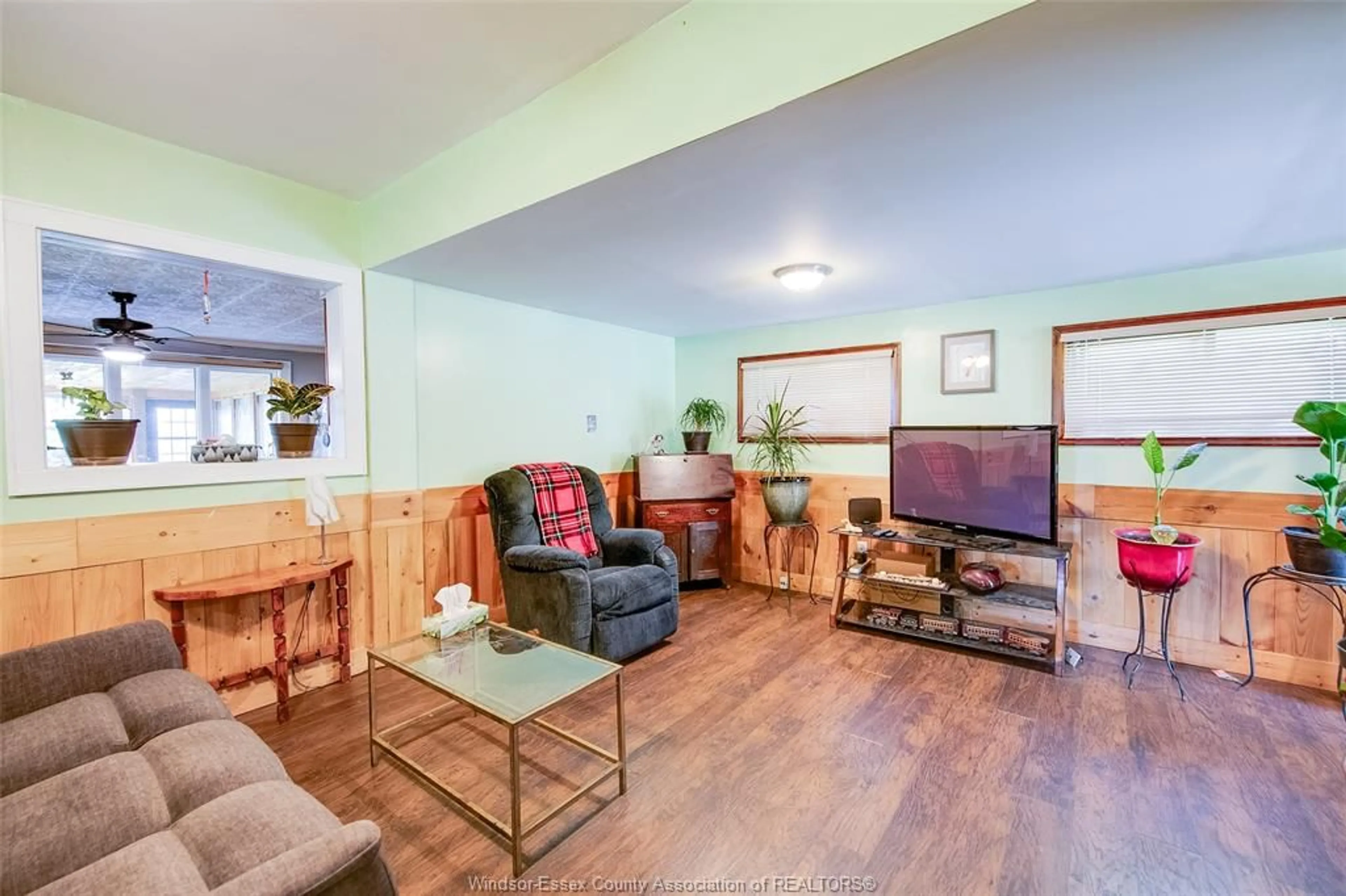 Living room with furniture, wood/laminate floor for 7039 FORD St, Lakeshore Ontario N0P 1J0