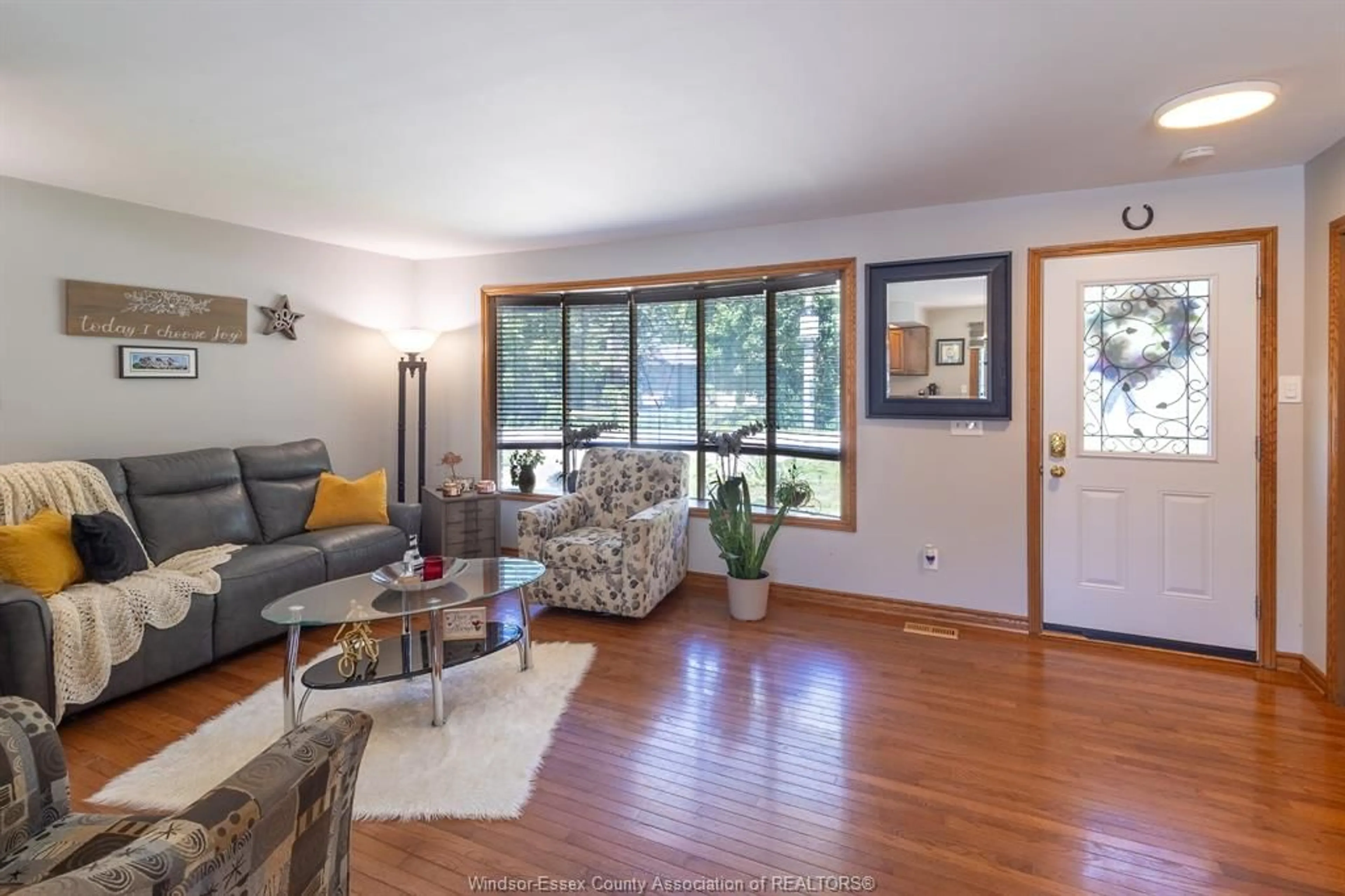 Living room with furniture, wood/laminate floor for 353 Cousineau Rd, Windsor Ontario N9G 1V6