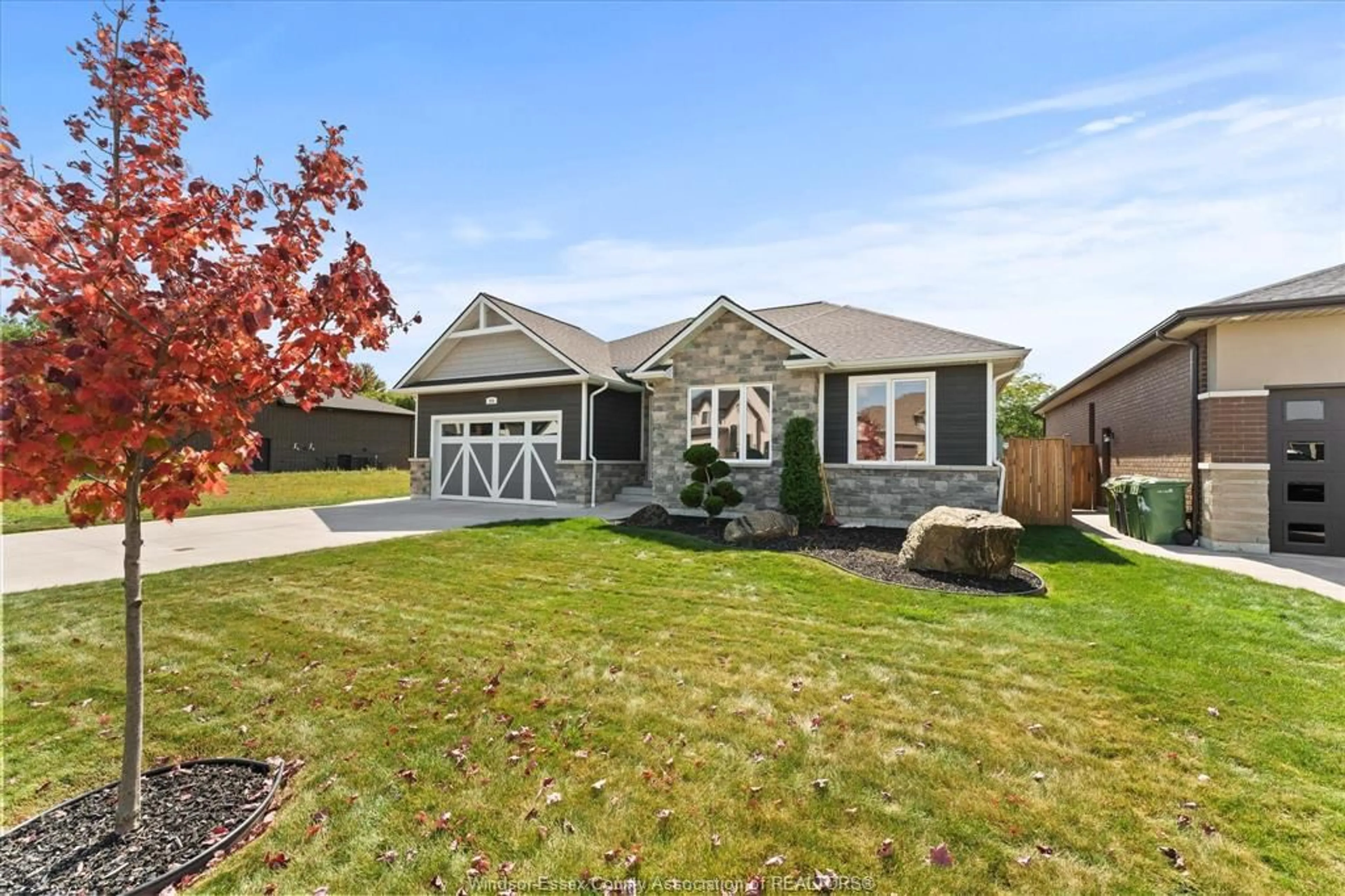 Home with vinyl exterior material, street for 256 Joan Flood Drive, Essex Ontario N8M 0C6