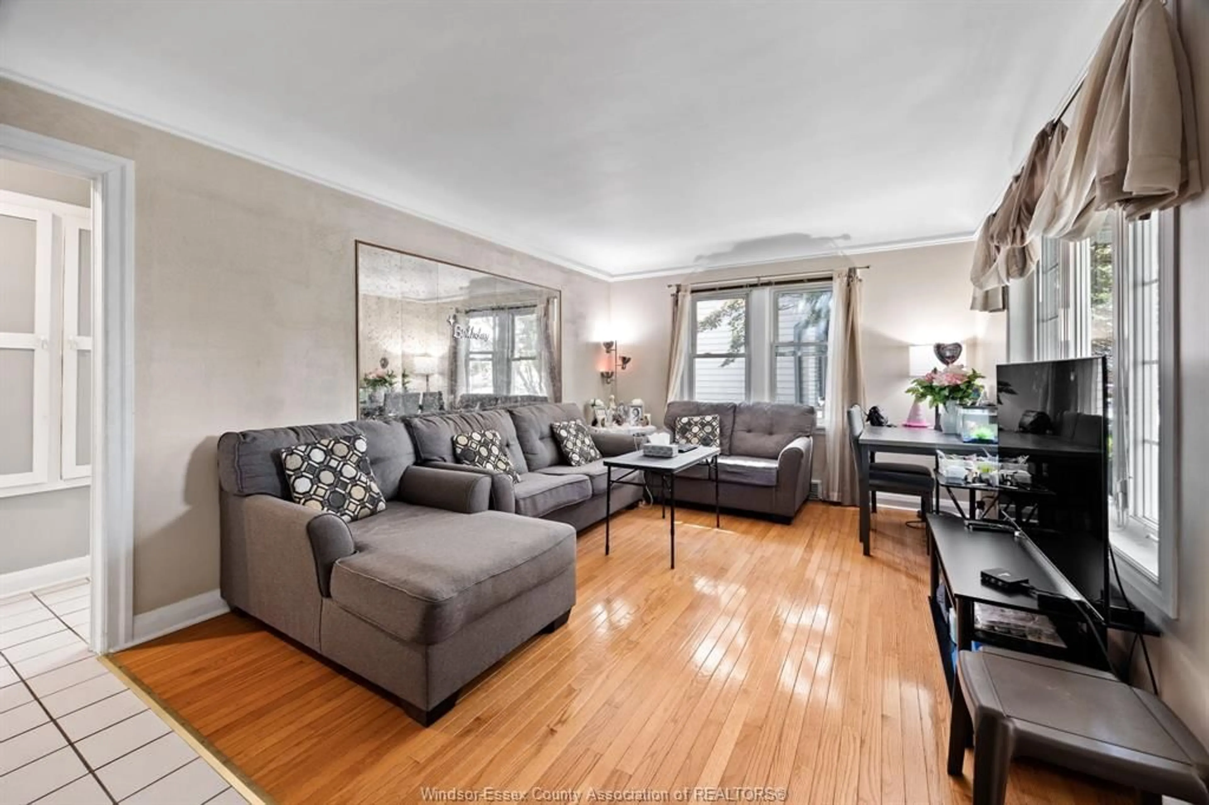 Living room with furniture, wood/laminate floor for 1418 PILLETTE, Windsor Ontario N8Y 3B6